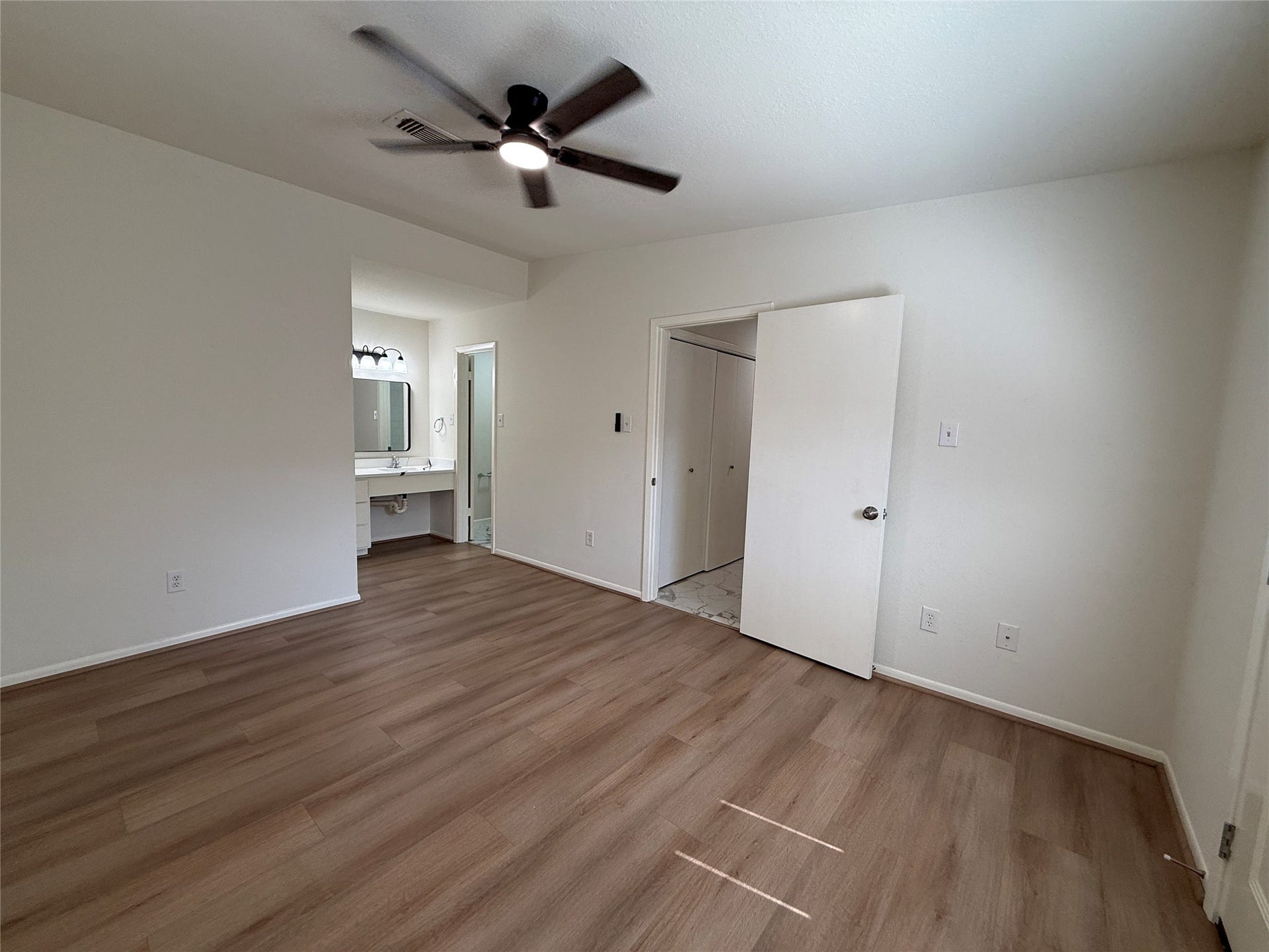 Primary bedroom with vinyl floors.