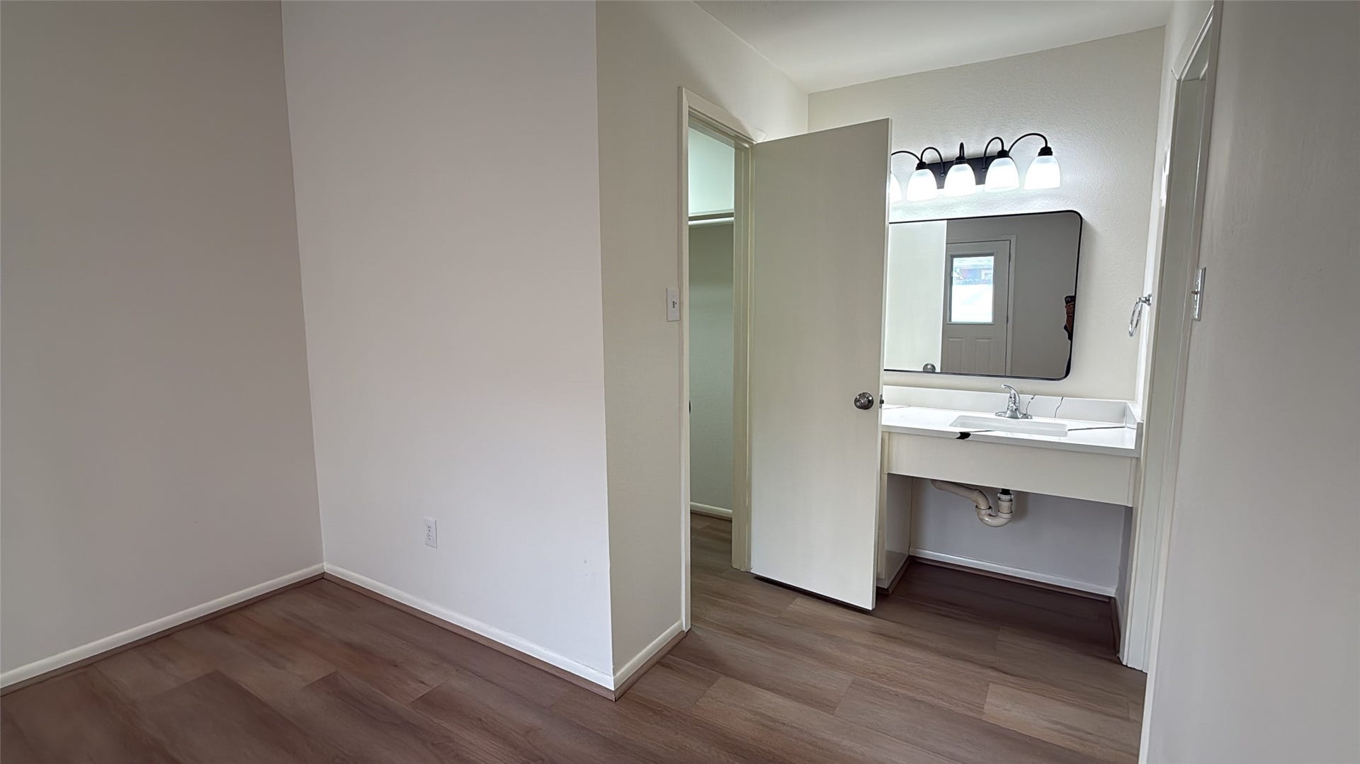 View of vanity and closet in primary bathroom.