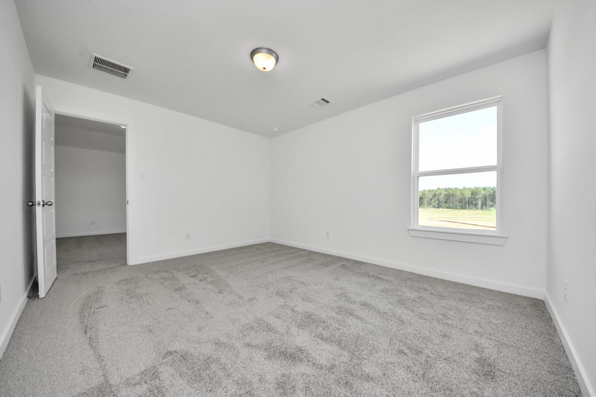 3072 Spoolwood Trail, Magnolia, TX 77355 Generously sized secondary bedrooms featuring spacious closets, soft and inviting carpeting underfoot, large windows allowing plenty of natural light, and the added touch of privacy blinds for your personal retreat.