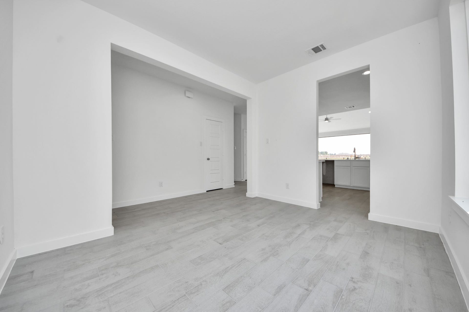 3072 Spoolwood Trail, Magnolia, TX 77355 Create lasting memories with your family and friends at the dining table! This expansive dining room showcases sophisticated flooring, custom paint, and seamlessly connects to the family room and kitchen, providing an open and inviting atmosphere