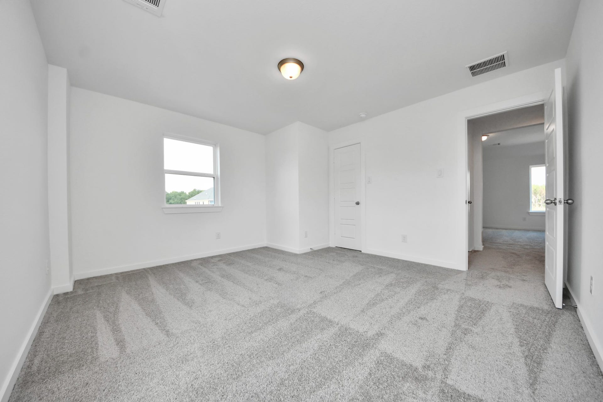 3072 Spoolwood Trail, Magnolia, TX 77355 Generously sized secondary bedrooms featuring spacious closets, soft and inviting carpeting underfoot, large windows allowing plenty of natural light, and the added touch of privacy blinds for your personal retreat.