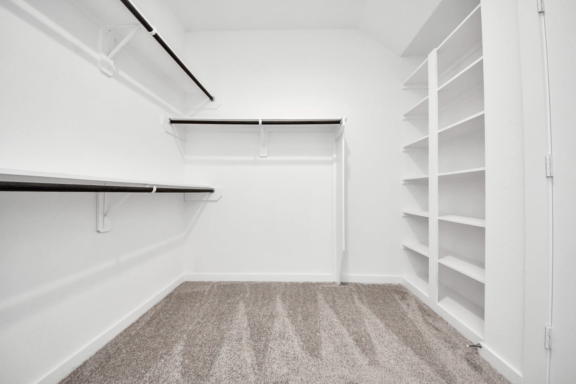 3072 Spoolwood Trail, Magnolia, TX 77355 Walk-in closet that epitomizes luxury and practicality. This generously sized space features built-in shelving, offering abundant room for impeccable organization. High ceilings and recessed lighting create a bright and welcoming ambiance.