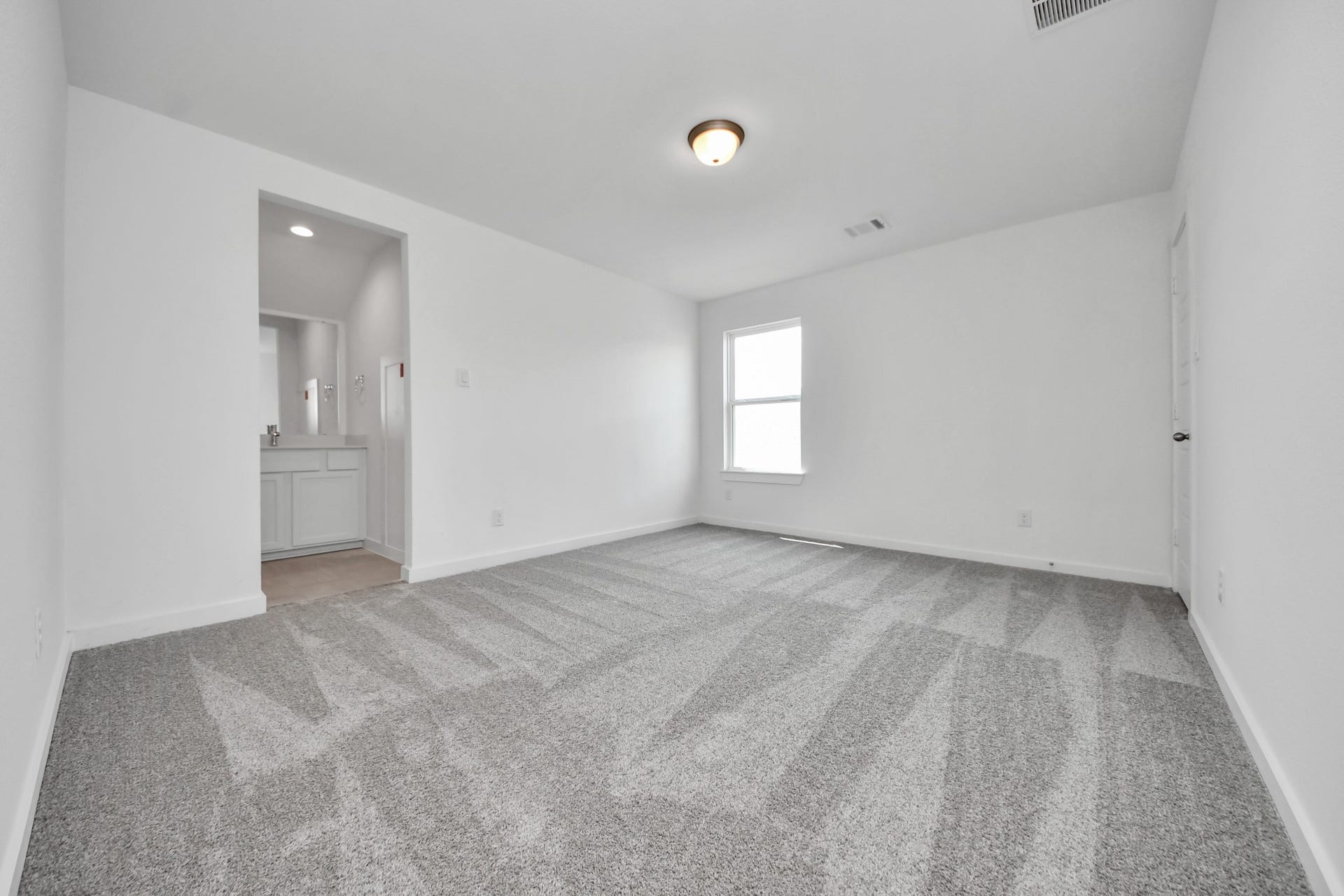 3072 Spoolwood Trail, Magnolia, TX 77355 Secondary bedroom features plush carpeting, large windows that let in plenty of natural light, bright paint, and spacious closets.