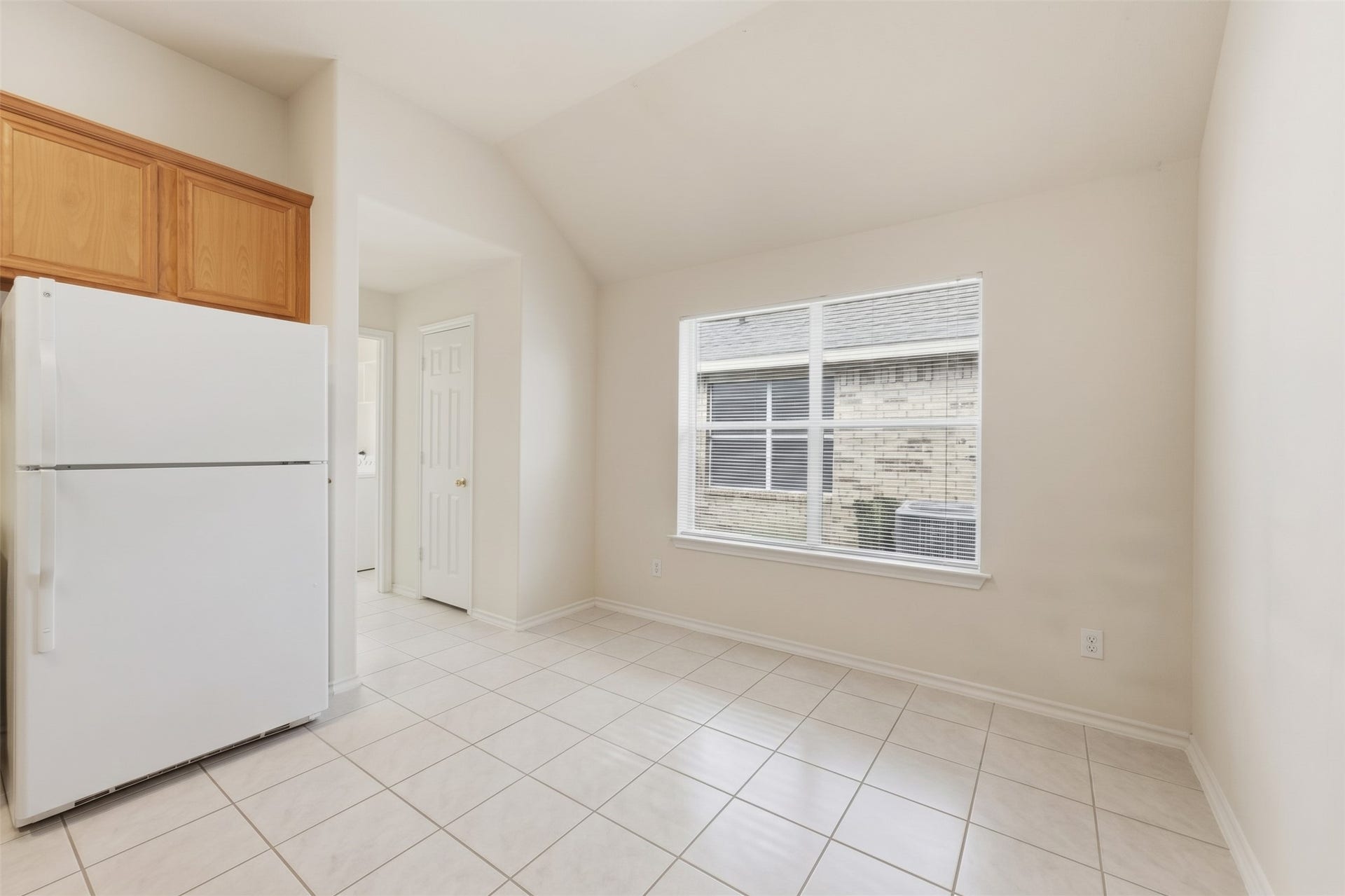 2426 Floral Ridge Drive, Spring, TX 77388 Bright kitchen area with large window, tiled flooring, and ample cabinet space.