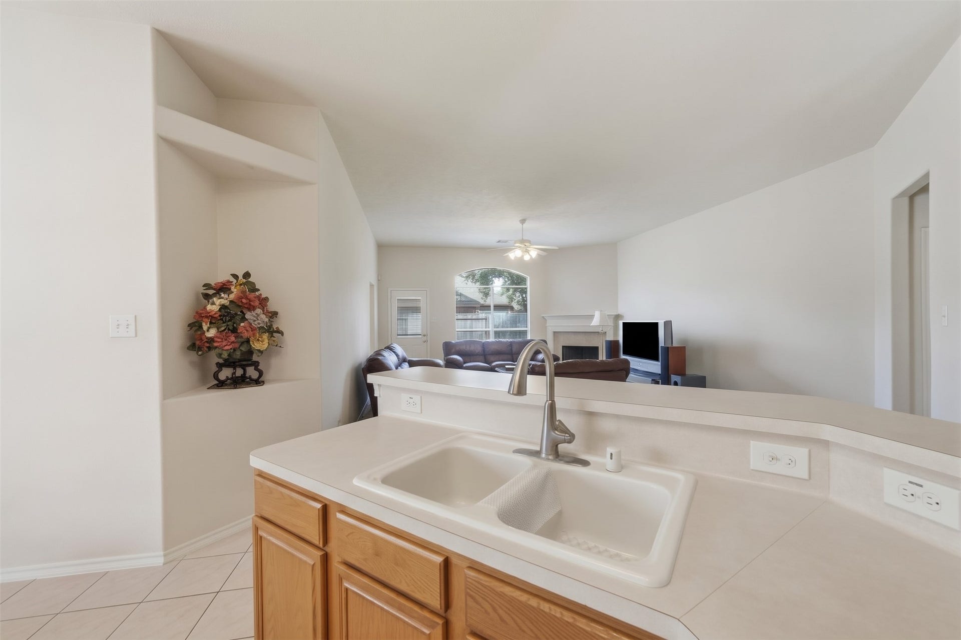 2426 Floral Ridge Drive, Spring, TX 77388 Spacious open-concept living area with a view from the kitchen sink, featuring a cozy living room, neutral tones, and abundant natural light.