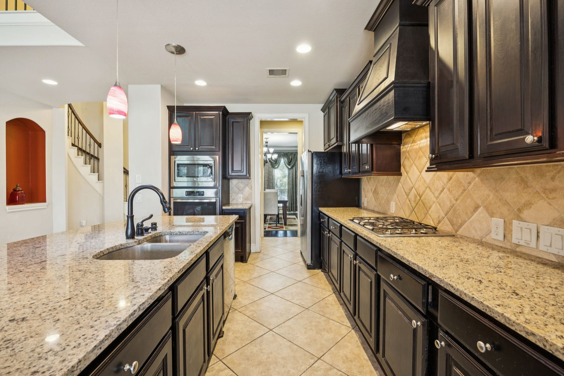 Dream kitchen featuring granite countertops, a large island, and dark wood cabinetry. Perfect for the home chef!