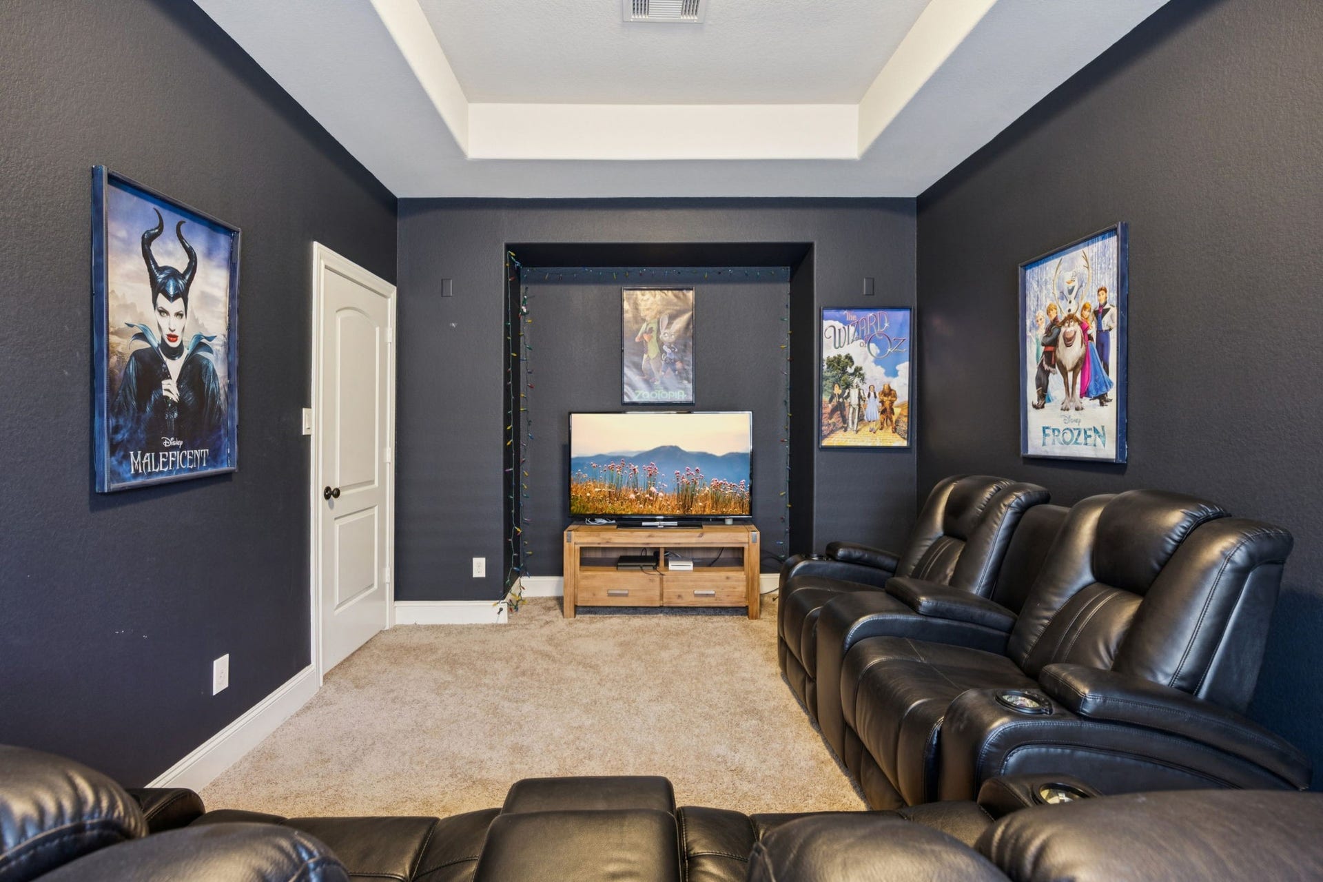 Adjacent to the expansive gameroom, this dedicated media room is designed for an immersive cinematic experience. The space features a sophisticated tray ceiling and ample dimensions for comfortable theater seating.