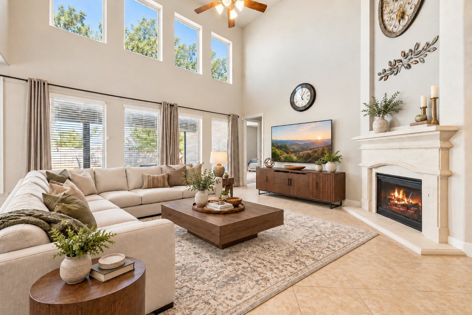 Anchored by a gas log fireplace with a cast stone mantle, this grand family room serves as a stunning architectural centerpiece. The space is virtually staged to illustrate its expansive layout.