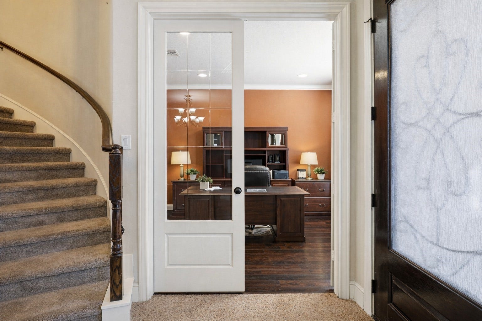 Accessed from the grand entry via elegant French doors, this private study features rich flooring and front-facing views. The perfect professional retreat or library. Virtually staged so you can imagine the possibilities.