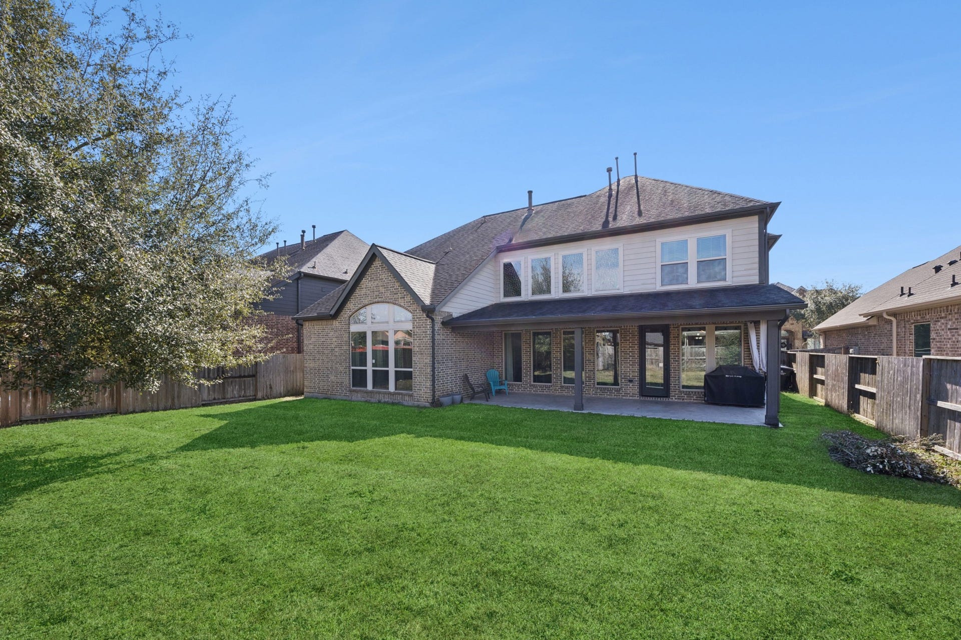 Step out to a large covered patio and a fully fenced backyard with a sprinkler system. Perfect for summer BBQs!