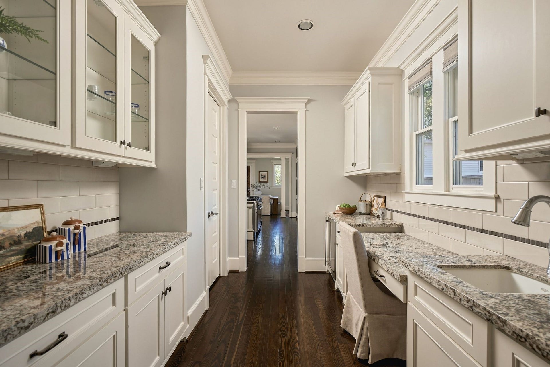 2012 Harvard Street, Houston, TX 77008 The butler's pantry includes a built-in beverage refrigerator, extra storage, second sink area for meal prep, wet bar, coffee area and a dedicated desk nook for organizing the week ahead.