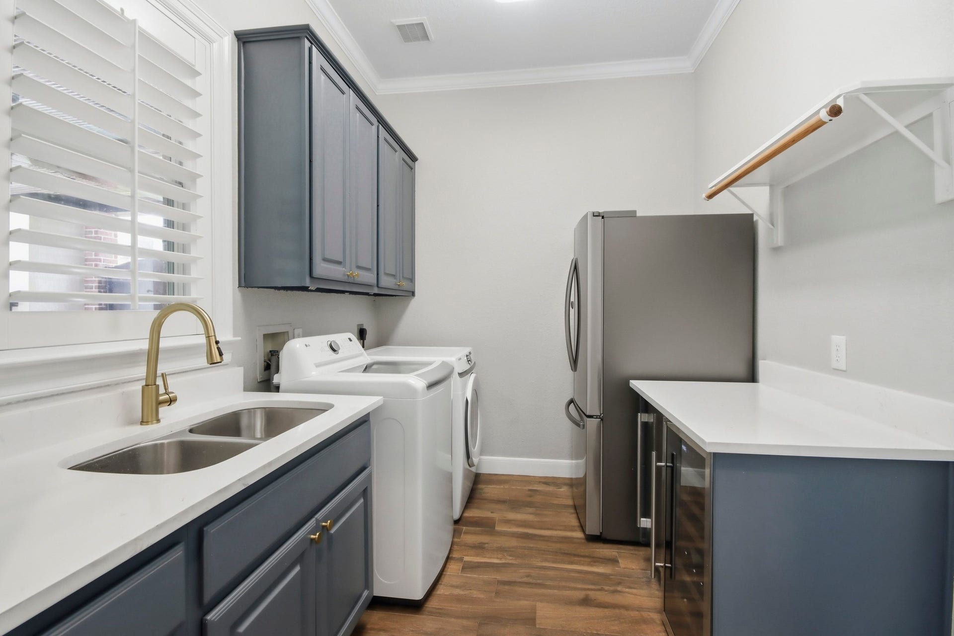 Stylish and functional, this laundry room features modern cabinetry, modern appliances, and ample counter space for efficient and enjoyable laundry days.