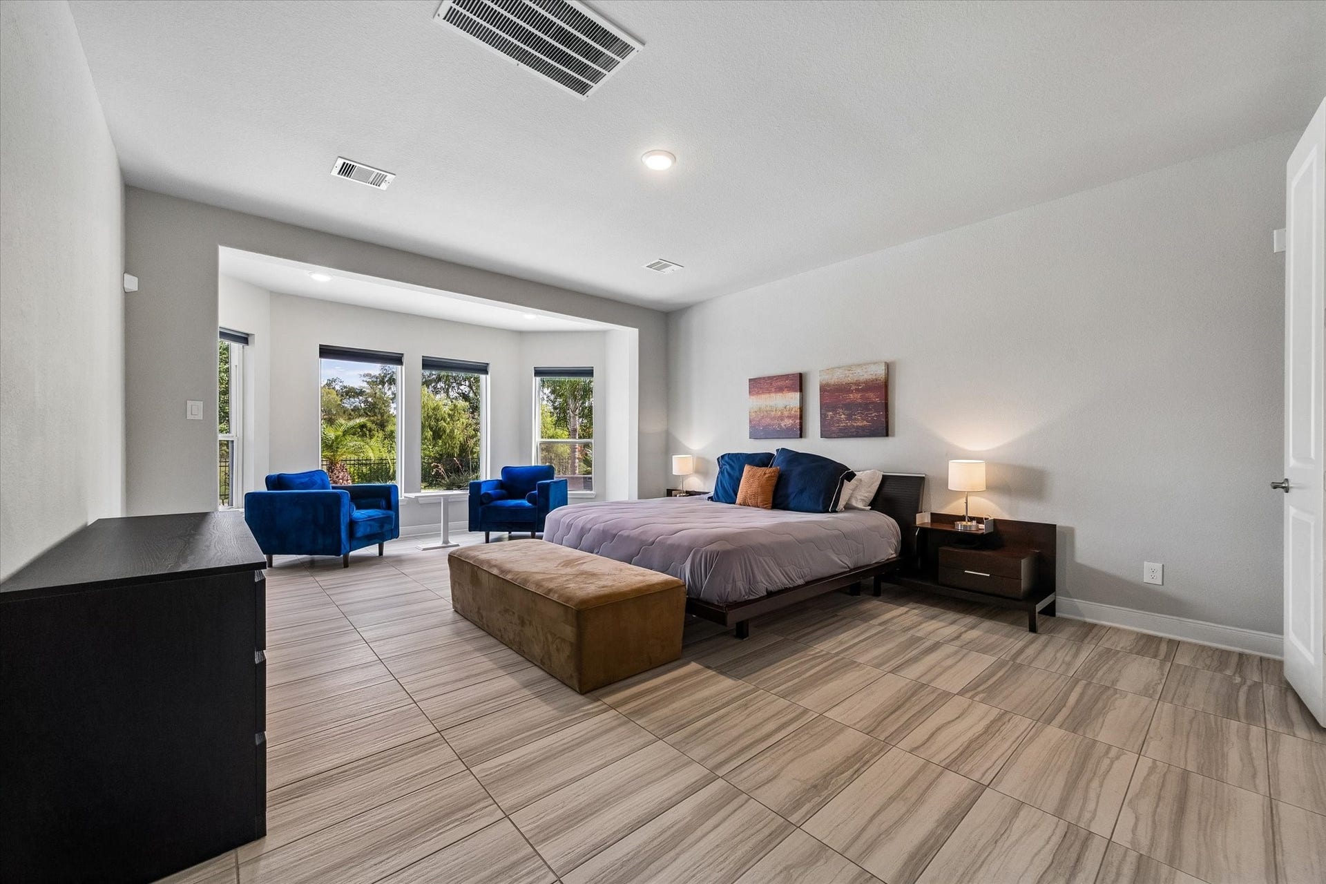 21322 Prairie Plains Lane, Richmond, TX 77406 True oasis of a primary bedroom with spacious seating area to overlook stunning nature views and pool area.
