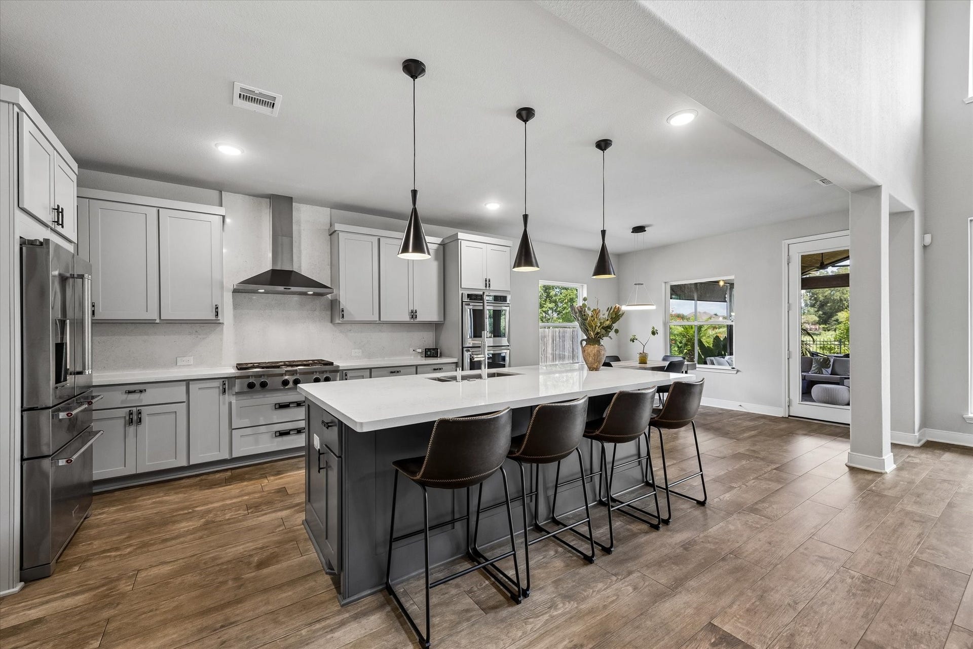 21322 Prairie Plains Lane, Richmond, TX 77406 Oversized quartz island provides ample seating and Kitchen Aid appliance package, 6 burner gas stove top, double oven and large breakfast room perfect for hosting holidays.