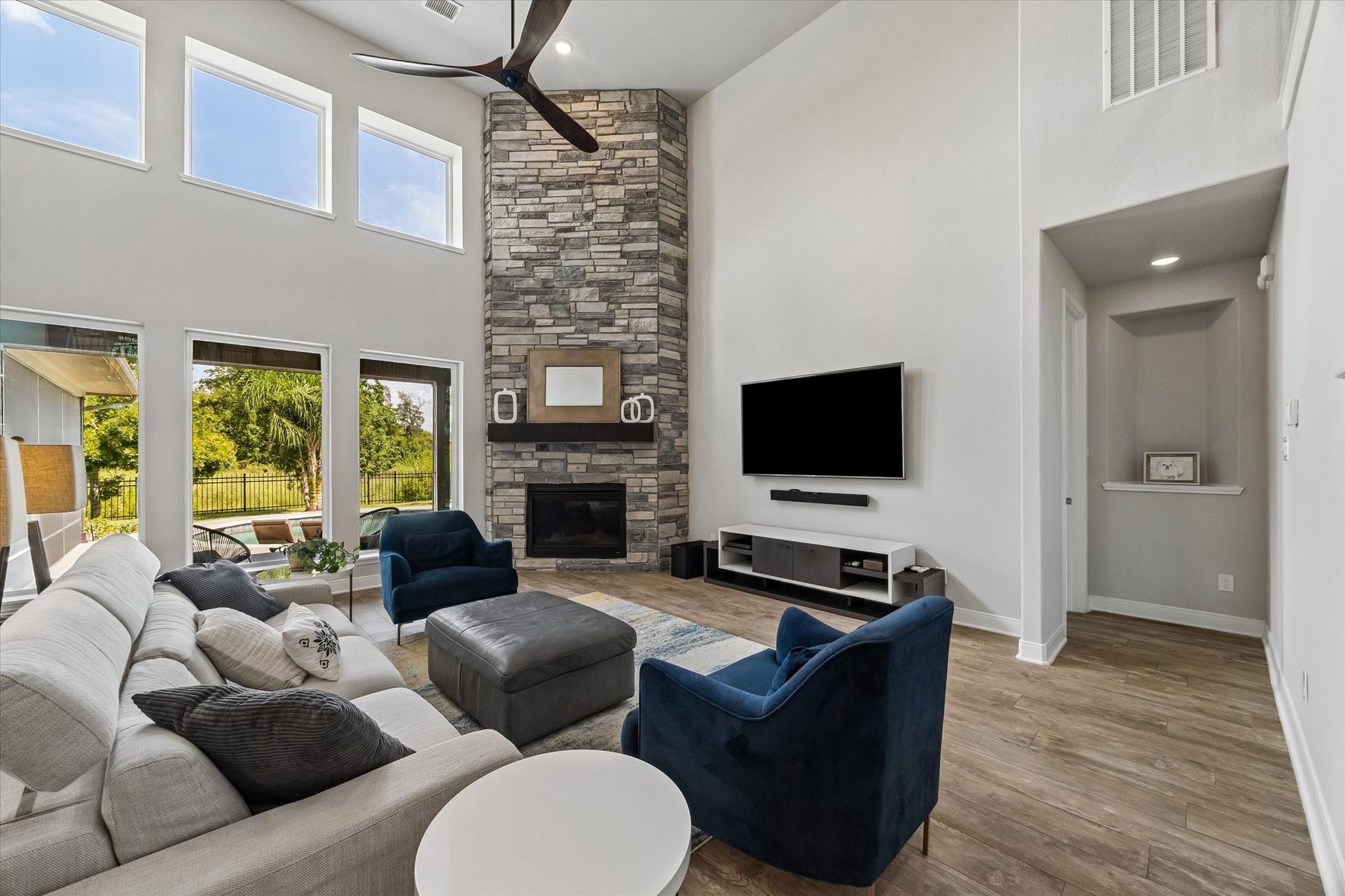 21322 Prairie Plains Lane, Richmond, TX 77406 Over 18 foot ceilings, stone fireplace, and tile floors create liveable space with views that AI didn't create! North/South exposure is a bonus and the floorplan is ideal for entertaining and creating fabulous flow.
