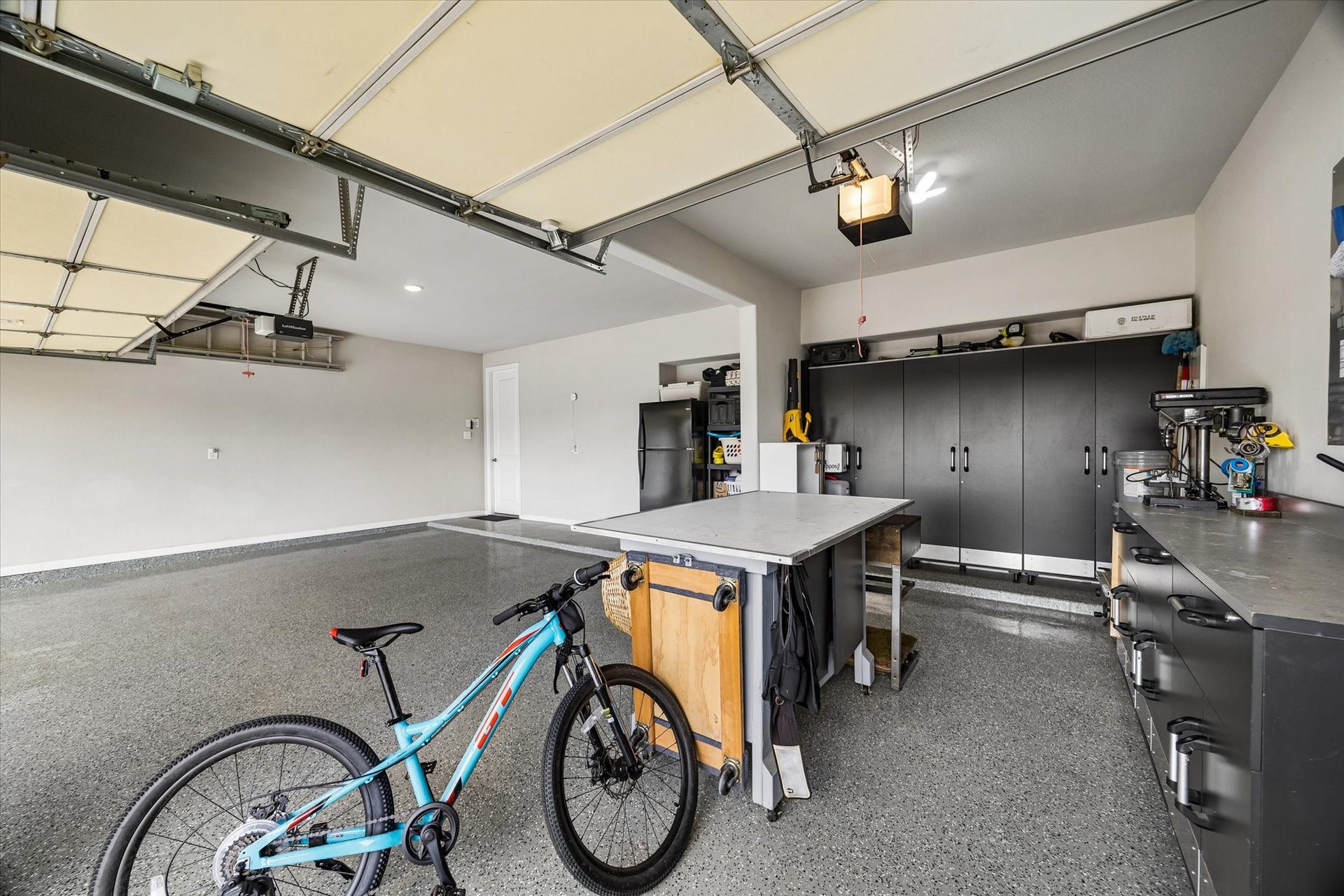 21322 Prairie Plains Lane, Richmond, TX 77406 Oversized three car garage features epoxy coating and room for work or hobbies
