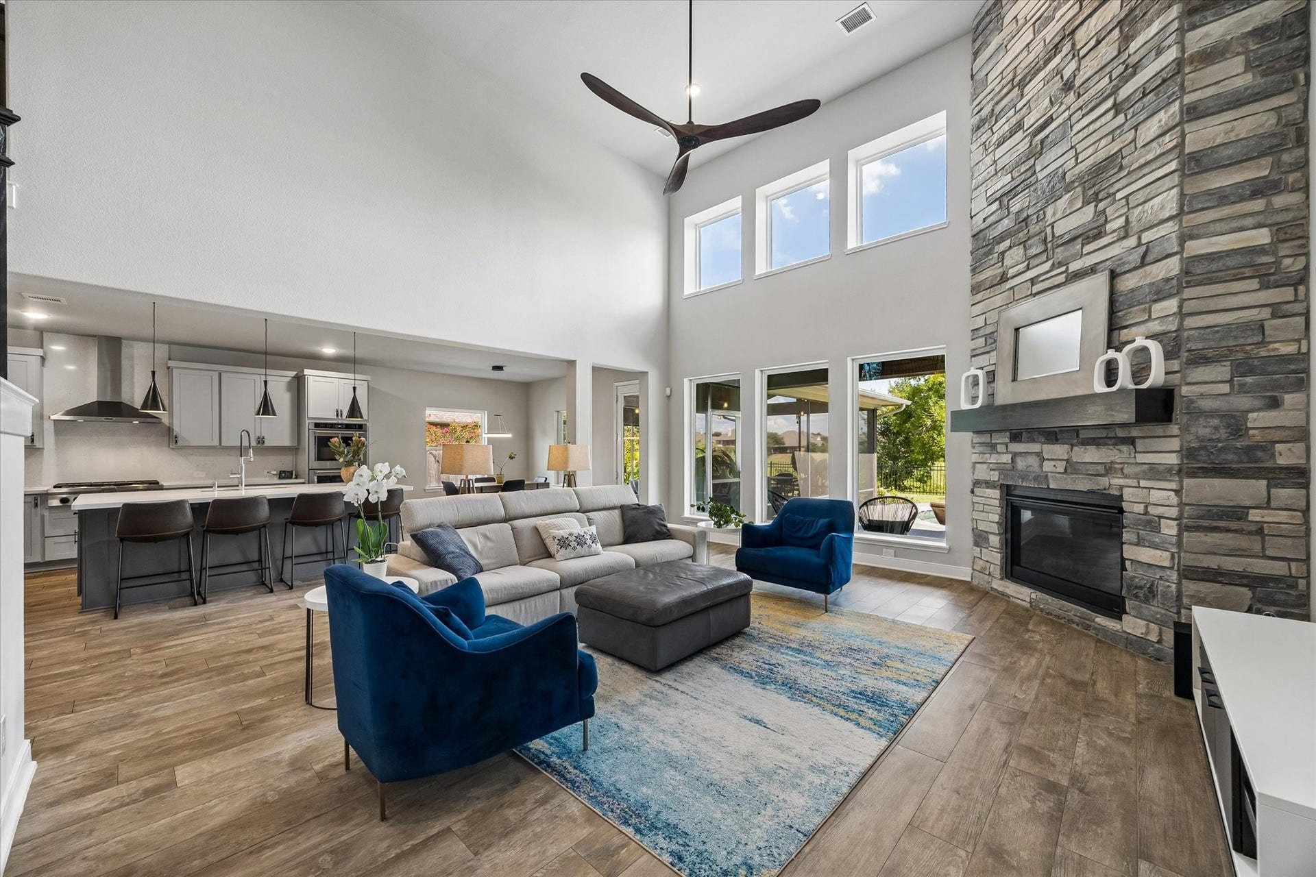 21322 Prairie Plains Lane, Richmond, TX 77406 Great room with soaring ceilings, stone hearth surround, and views of stunning south elevation