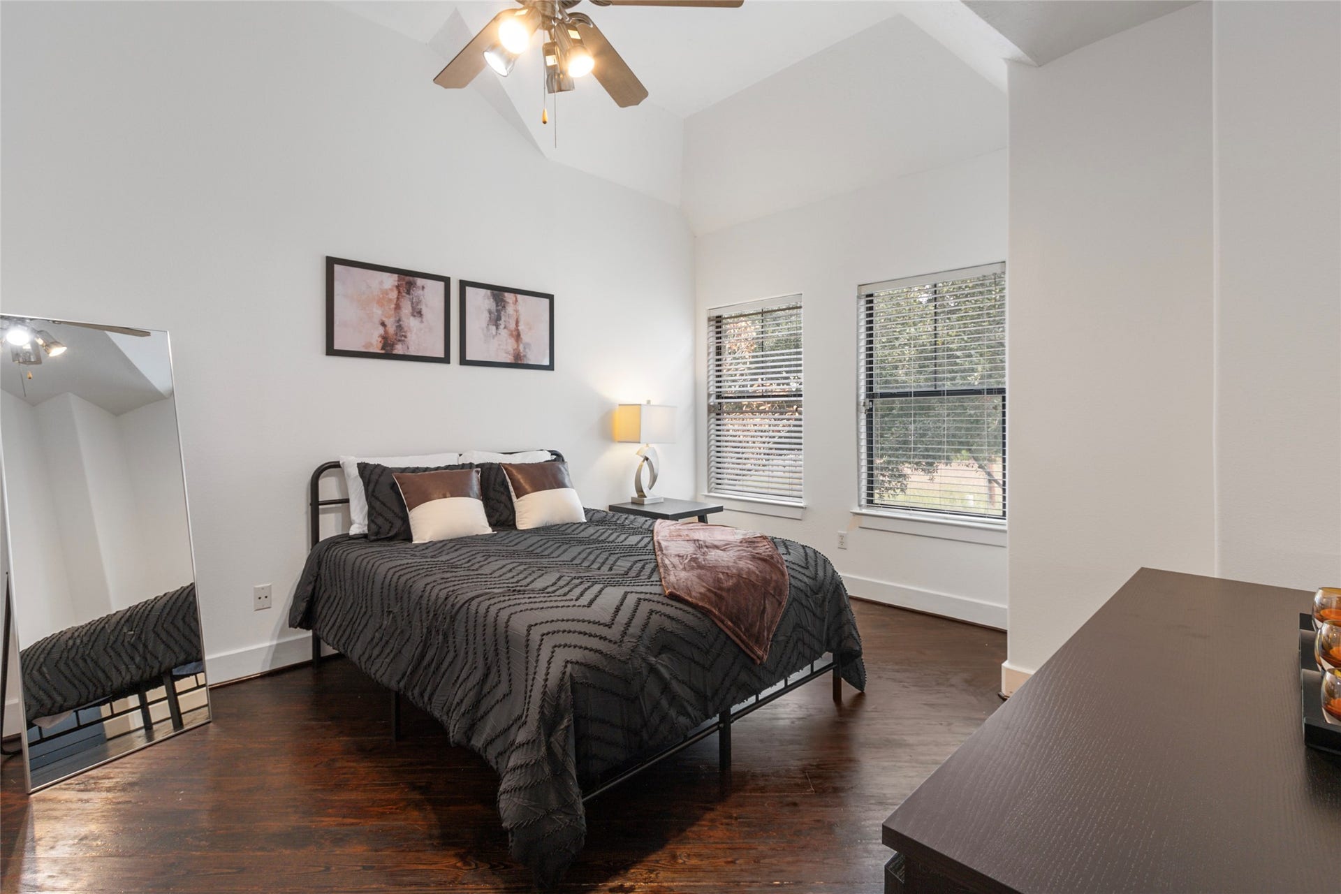 Bedroom with high ceilings, ceiling fan, and tall windows