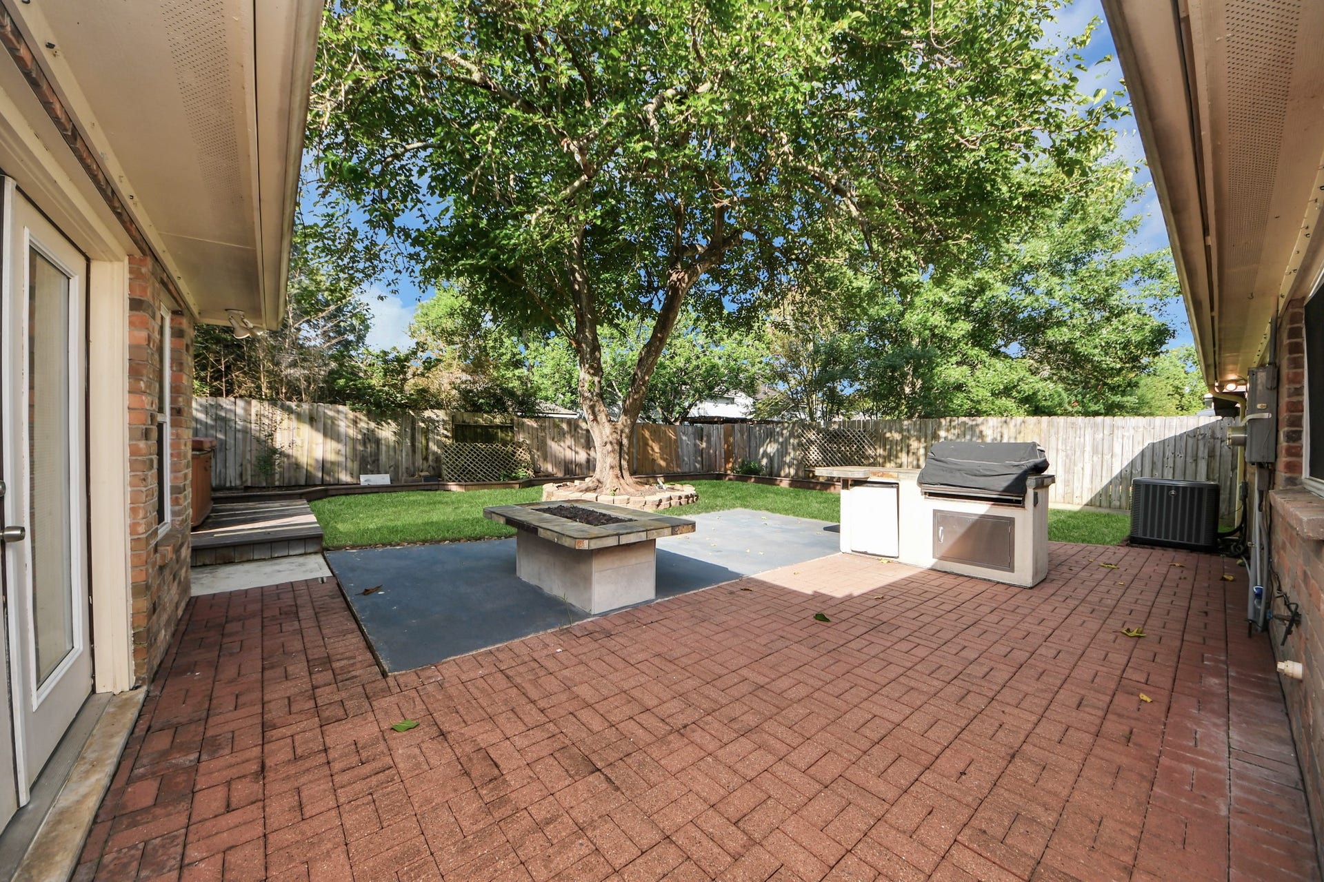 3402 Hidden Creek Drive, Sugar Land, TX 77479 Experience ultimate outdoor living with a fully equipped kitchen, hot tub, and fire pit featuring new tile. Enjoy the convenience of an outdoor fridge and enhanced landscaping for a perfect backyard retreat.