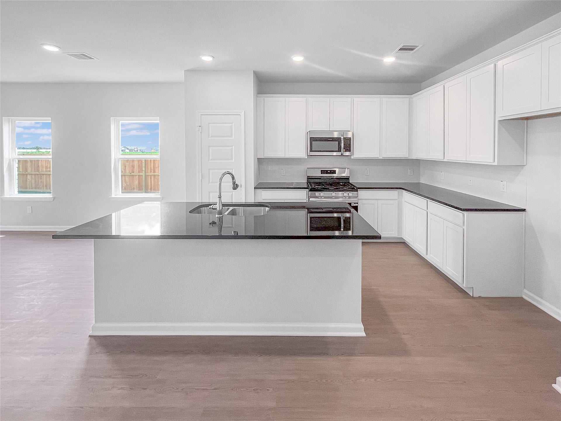 3442 Brushy Marsh Drive, Richmond, TX 77406 The Waring III- Kitchen with Large Island. Sample image for illustration; upgrades, options, and colors may vary.