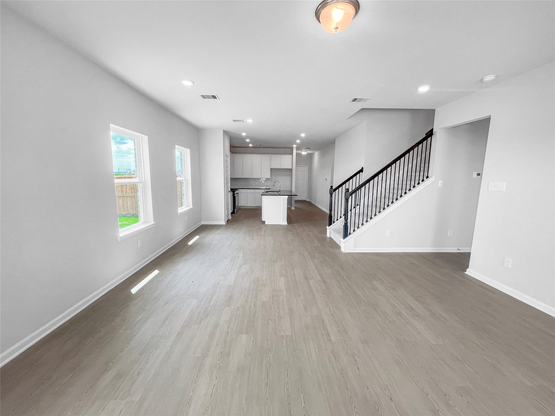 3442 Brushy Marsh Drive, Richmond, TX 77406 The Waring III- Family Room into Dining Area and Kitchen. Sample image for illustration; upgrades, options, and colors may vary.