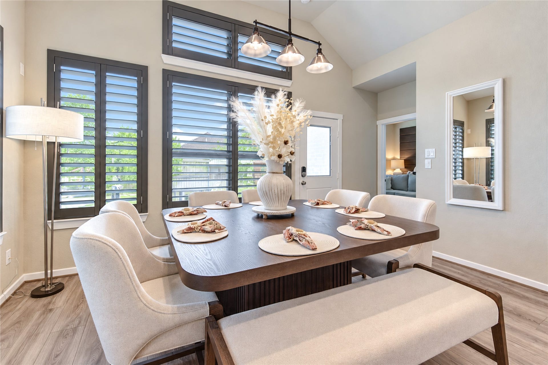 24911 Via Arabella Lane, Richmond, TX 77406 Natural light fills the dining area, with tall windows, plantation shutters and attractive pendant lighting.