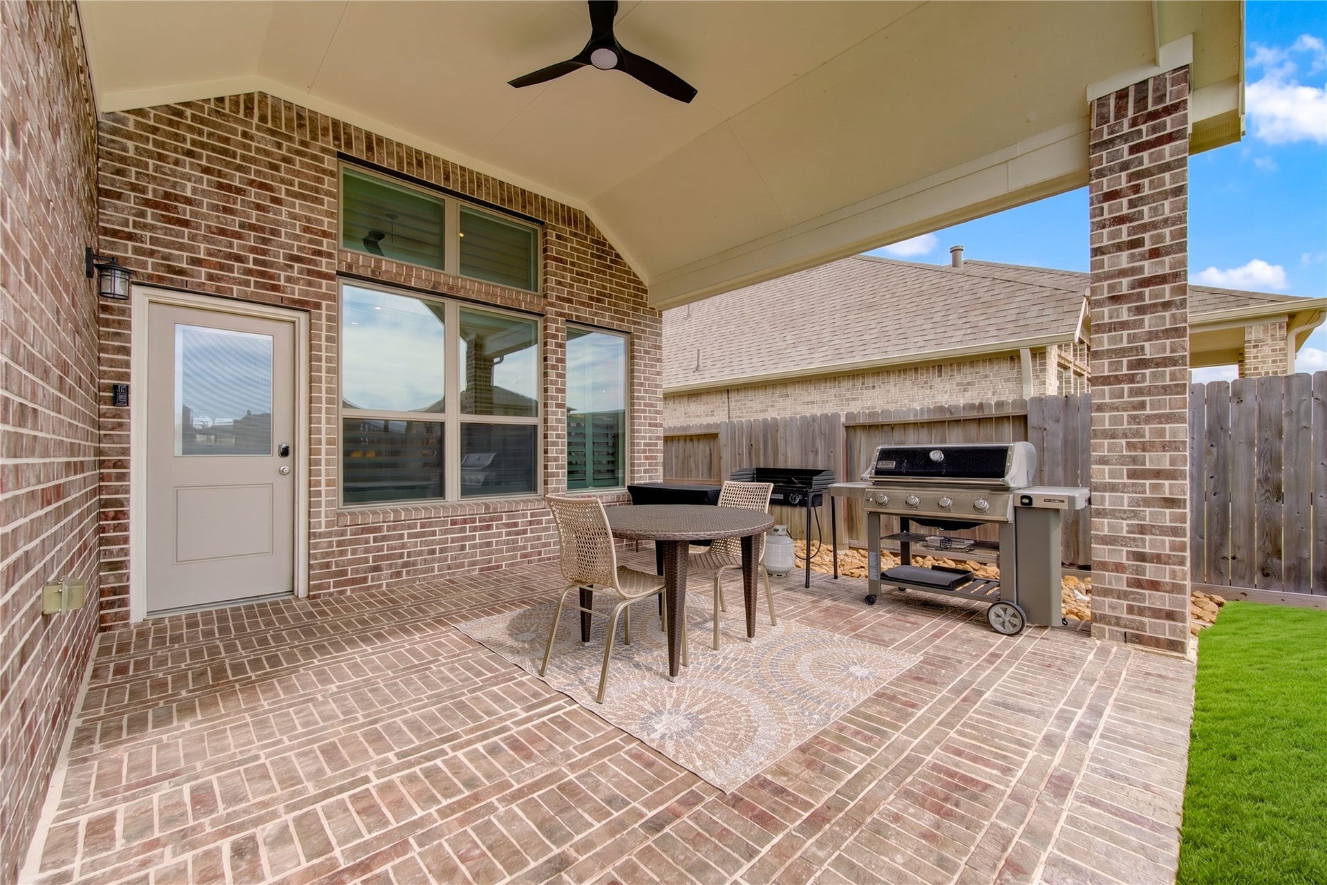 24911 Via Arabella Lane, Richmond, TX 77406 A generous covered patio with brick flooring, a ceiling fan and plenty of room for outdoor entertaining.