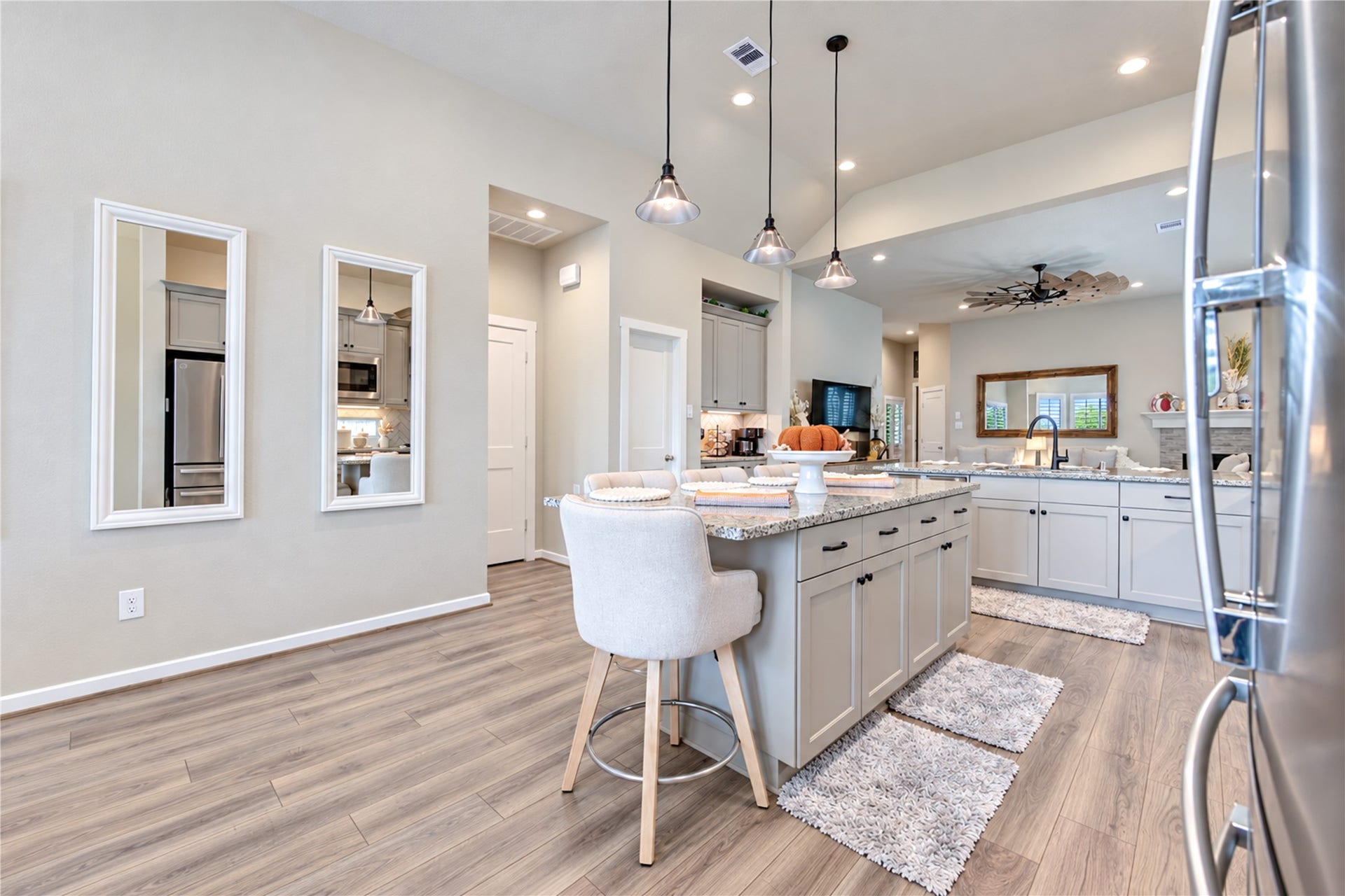 24911 Via Arabella Lane, Richmond, TX 77406 A generous center island provides additional seating, storage and workspace, with the family room just beyond.