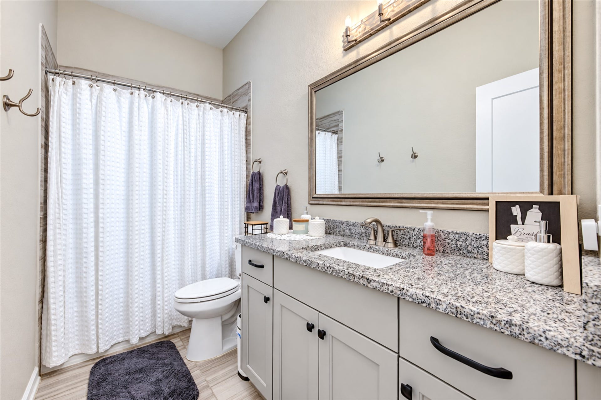 24911 Via Arabella Lane, Richmond, TX 77406 The secondary bathroom features a spacious vanity with granite countertops, generous cabinet storage and a tub/shower combination.