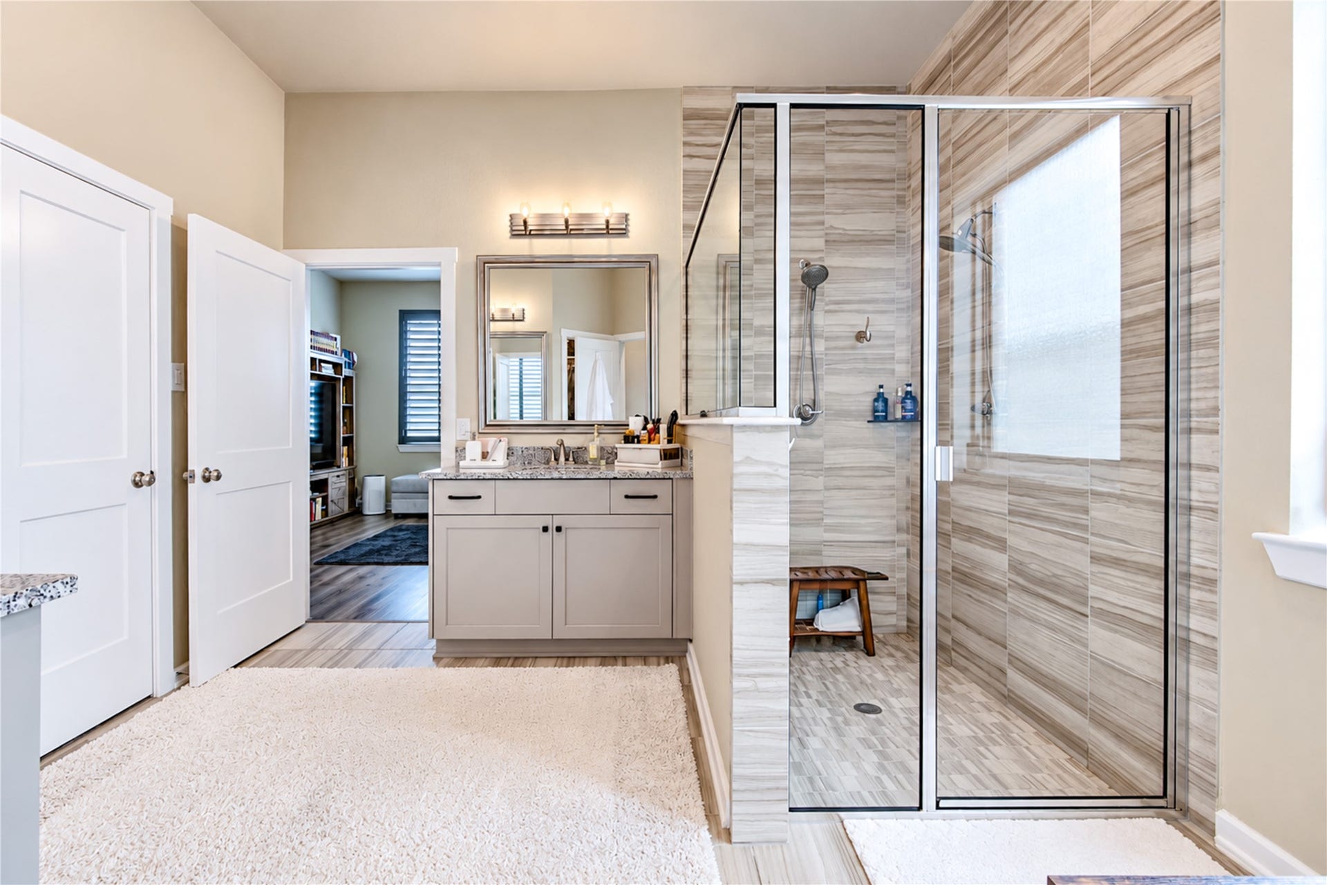 24911 Via Arabella Lane, Richmond, TX 77406 A closer look at the primary bath's large, glass-enclosed shower with floor-to-ceiling tile and dual showerheads.