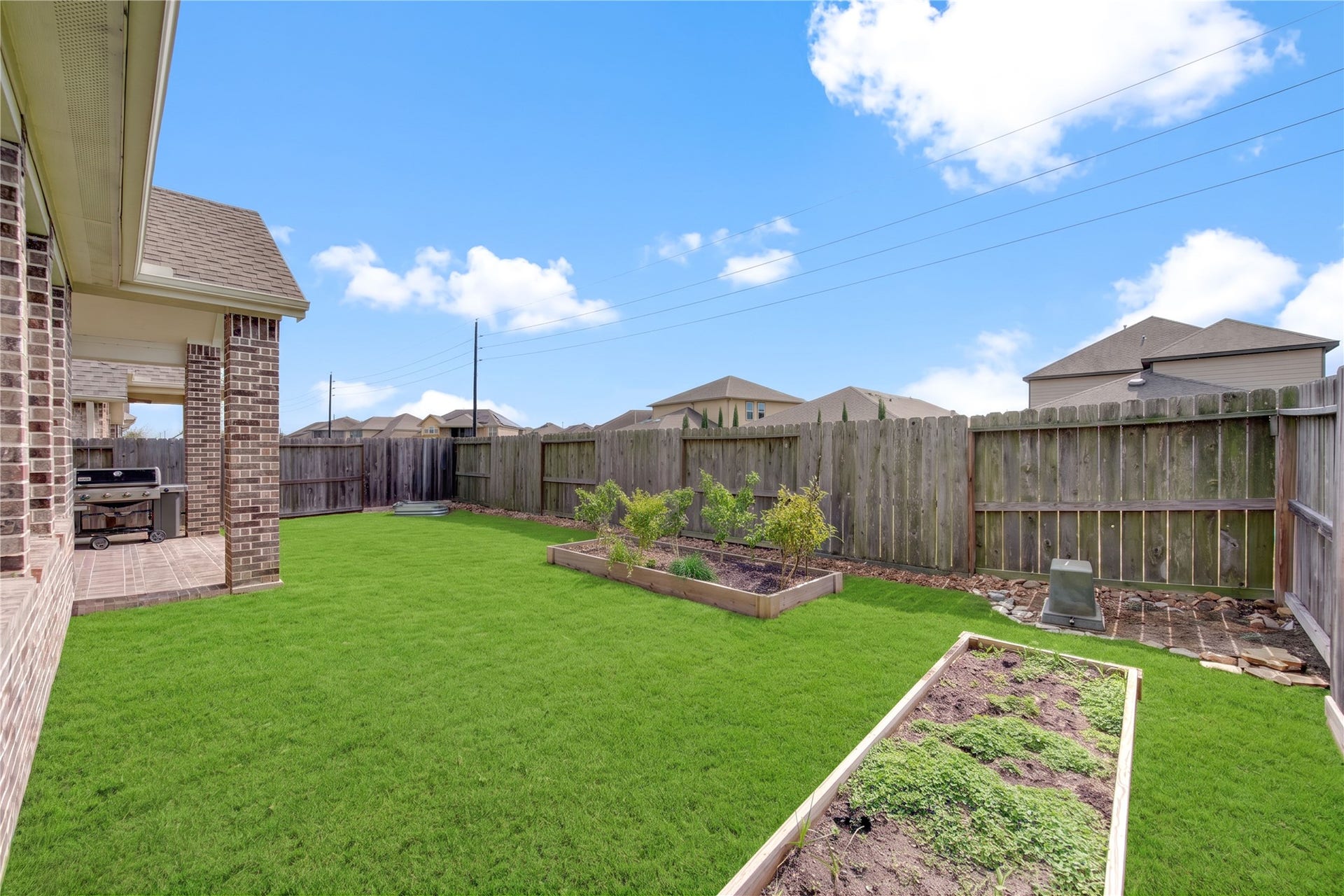 24911 Via Arabella Lane, Richmond, TX 77406 Another look at the backyard, offering open green space and a covered outdoor area.
