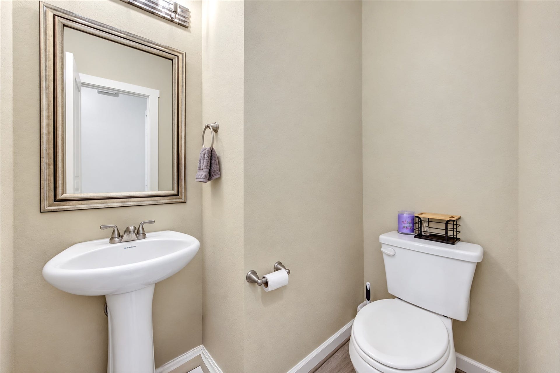 24911 Via Arabella Lane, Richmond, TX 77406 A conveniently located half bath featuring a pedestal sink and attractive finishes.