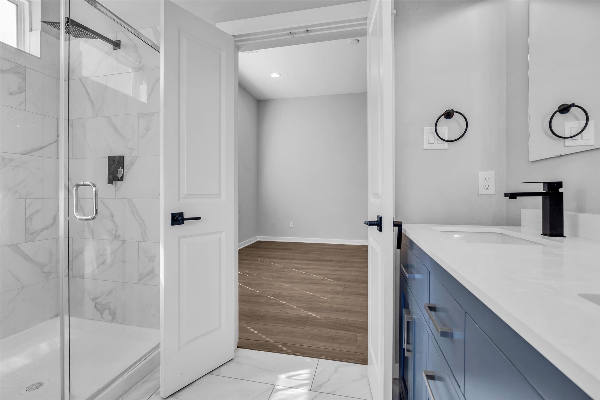 8474 Berry Green Lane, Houston, TX 77022 Start the day in the frameless glass shower with a rainfall showerhead for a spa-style feel.
