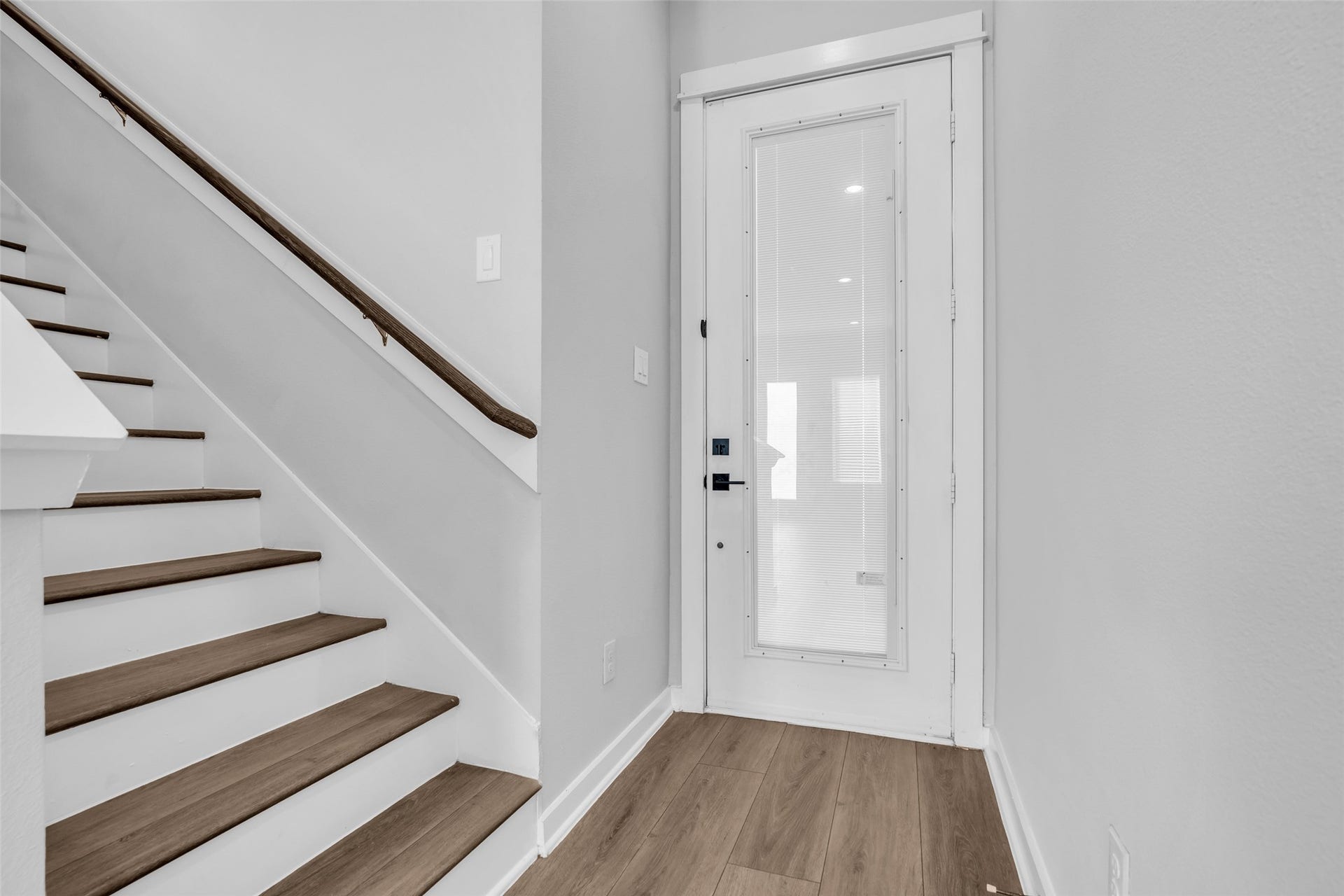 8474 Berry Green Lane, Houston, TX 77022 Step inside to wood-look plank floors and a staircase leading to all three bedrooms upstairs.