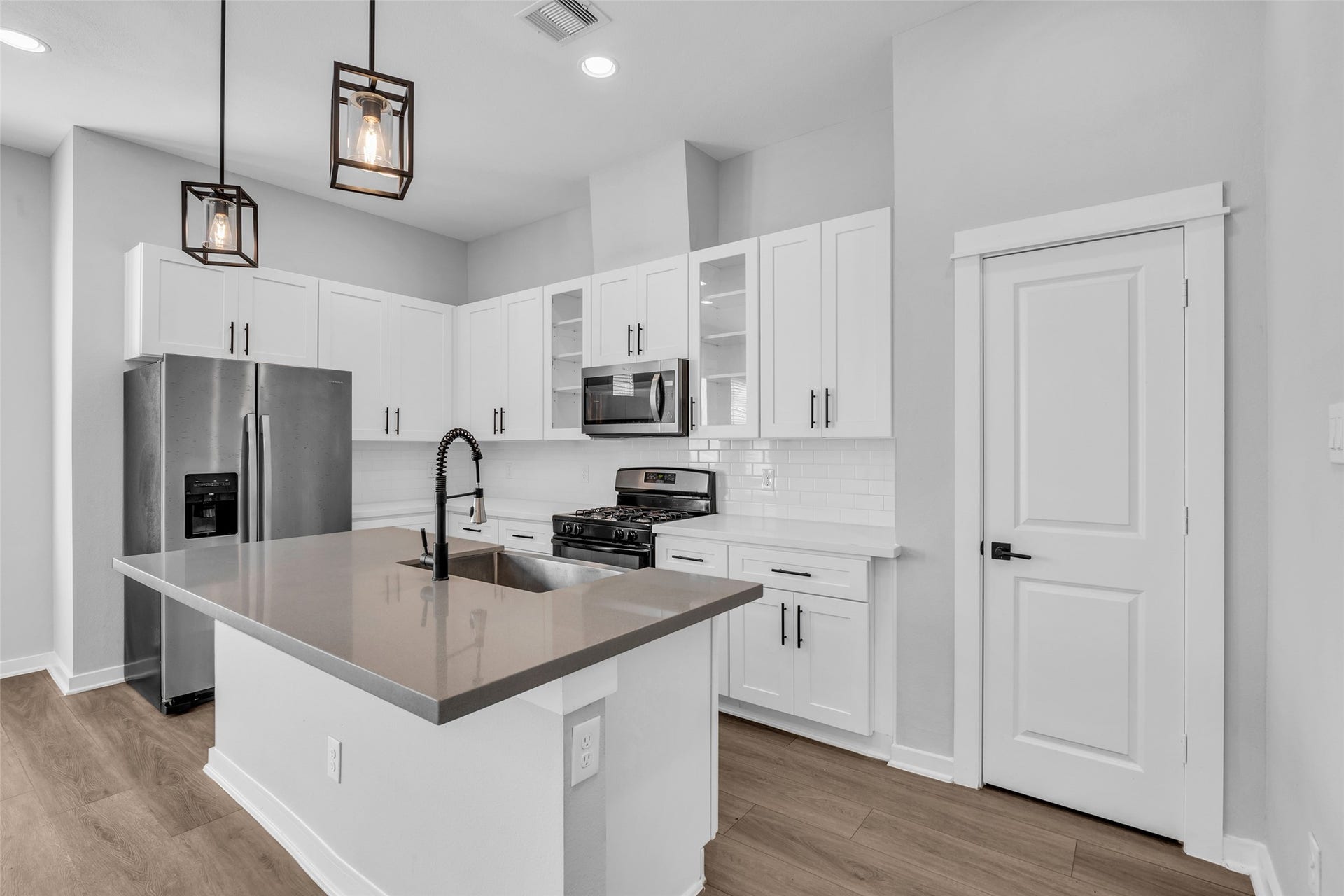 8474 Berry Green Lane, Houston, TX 77022 Prep, serve and chat at the oversized island, with the gas range just steps away.