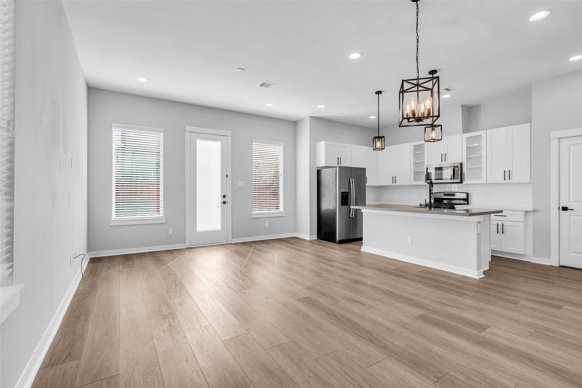 8474 Berry Green Lane, Houston, TX 77022 Open sightlines from the living room to the kitchen keep everyone connected while you cook.