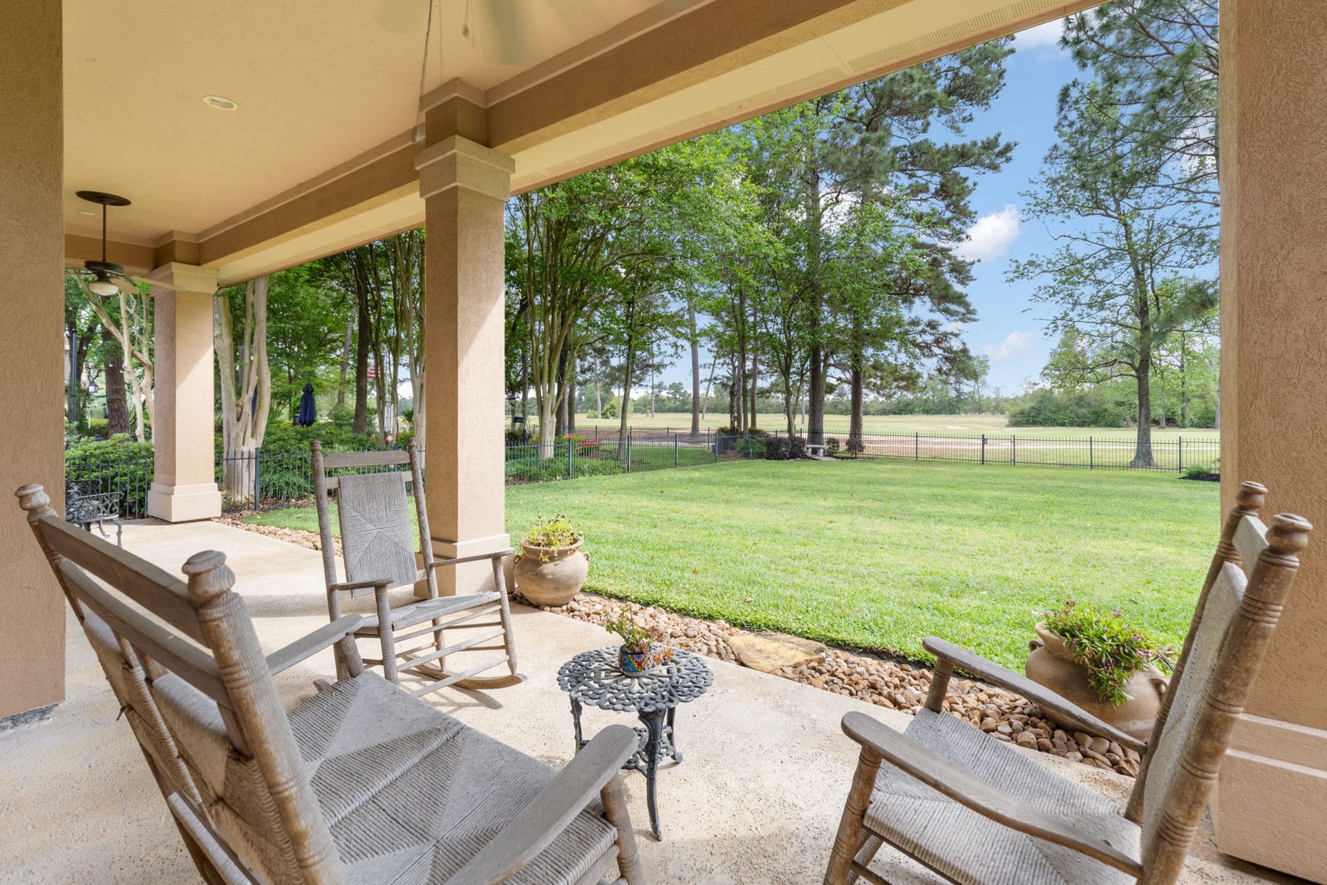 6207 Windrose Hollow Lane, Spring, TX 77379 The covered patio extends the living space outdoors with a direct view across the lawn and golf course. Sunset views from this area are a standout part of the homes lifestyle.