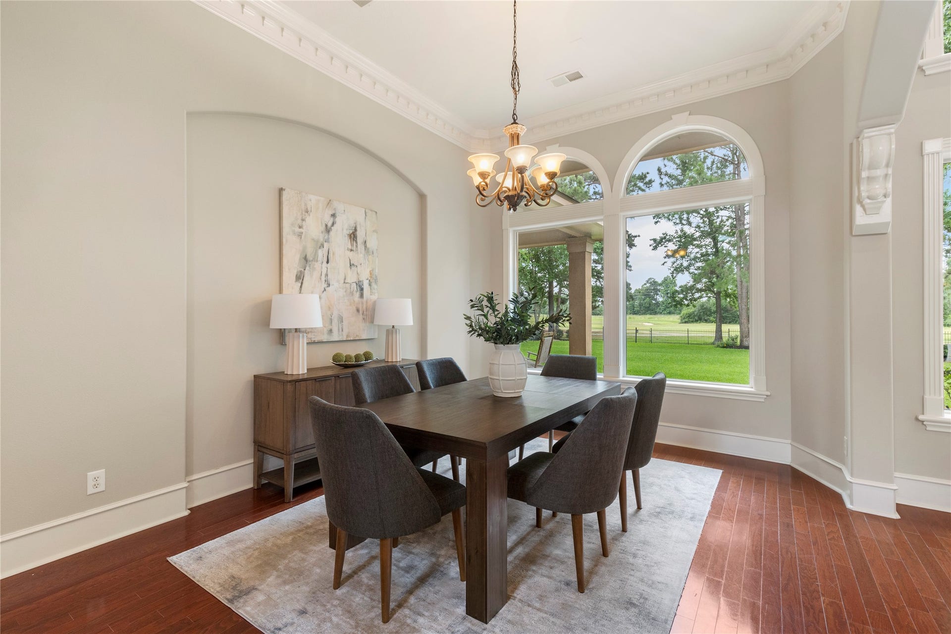 6207 Windrose Hollow Lane, Spring, TX 77379 Another view of the dining room highlights the connection between the formal spaces and the outdoors. Large windows make the room feel bright and connected to the homes scenic setting.