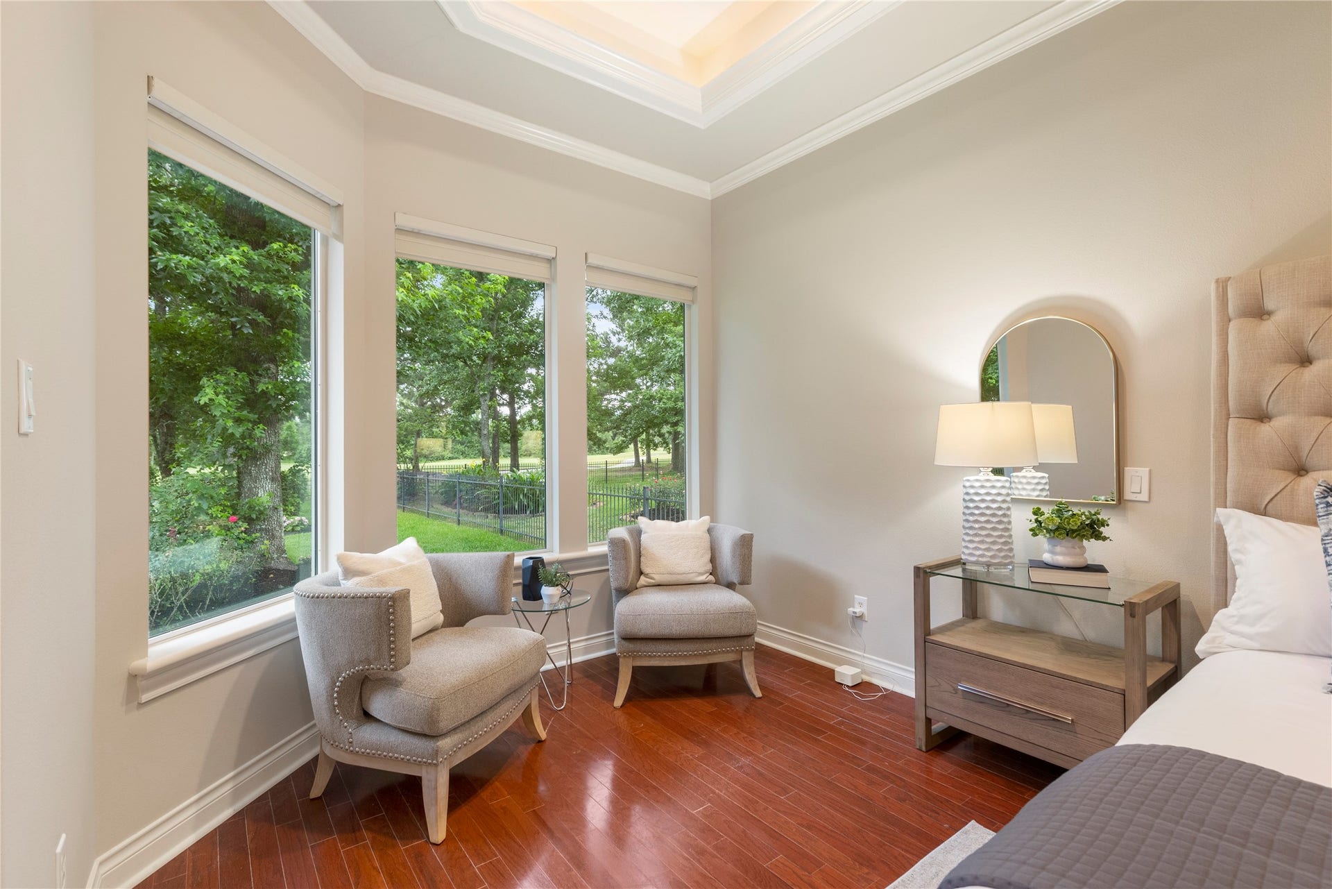6207 Windrose Hollow Lane, Spring, TX 77379 A sitting area surrounded by large windows captures expansive views of the backyard and golf course. The placement offers a peaceful vantage point over the double fairway setting.