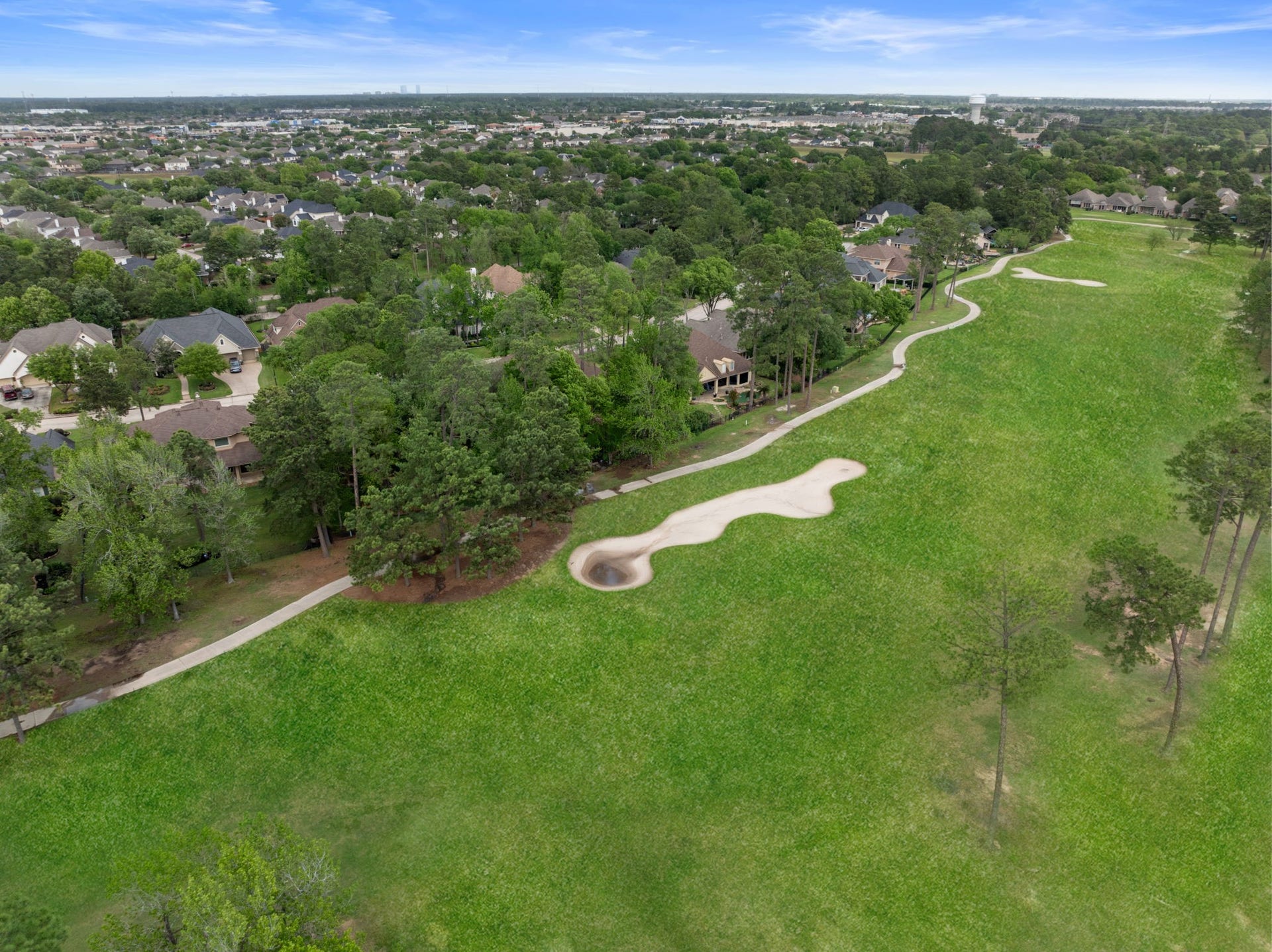 6207 Windrose Hollow Lane, Spring, TX 77379 Expansive golf course views open behind the property, offering a rare backdrop with no visible homes across the fairway. The setting creates a peaceful, resort like feel while still keeping daily conveniences close.