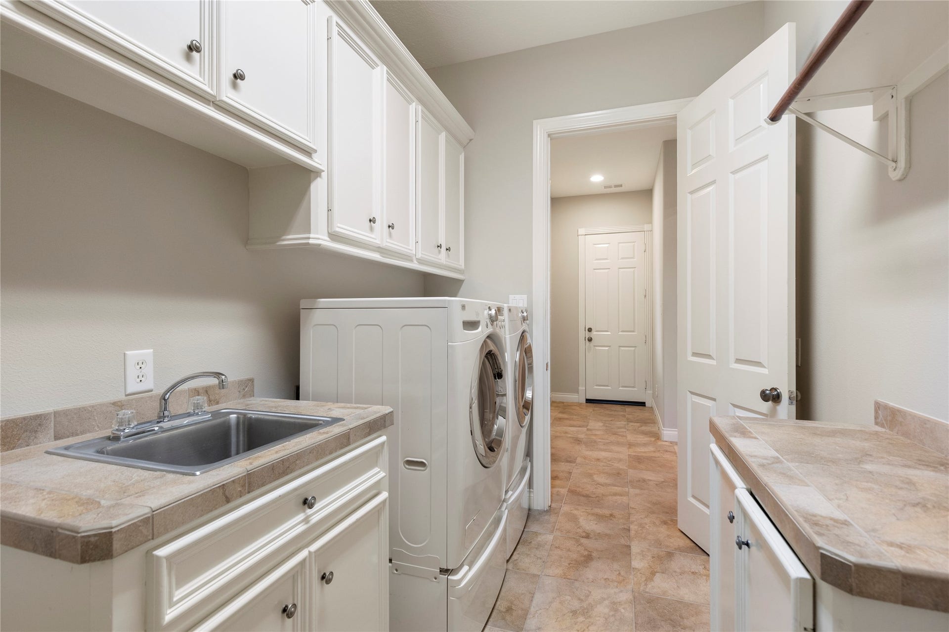6207 Windrose Hollow Lane, Spring, TX 77379 The utility room offers built in cabinetry, counter space, and a sink for added function. Its placement within the home keeps household tasks organized and accessible.