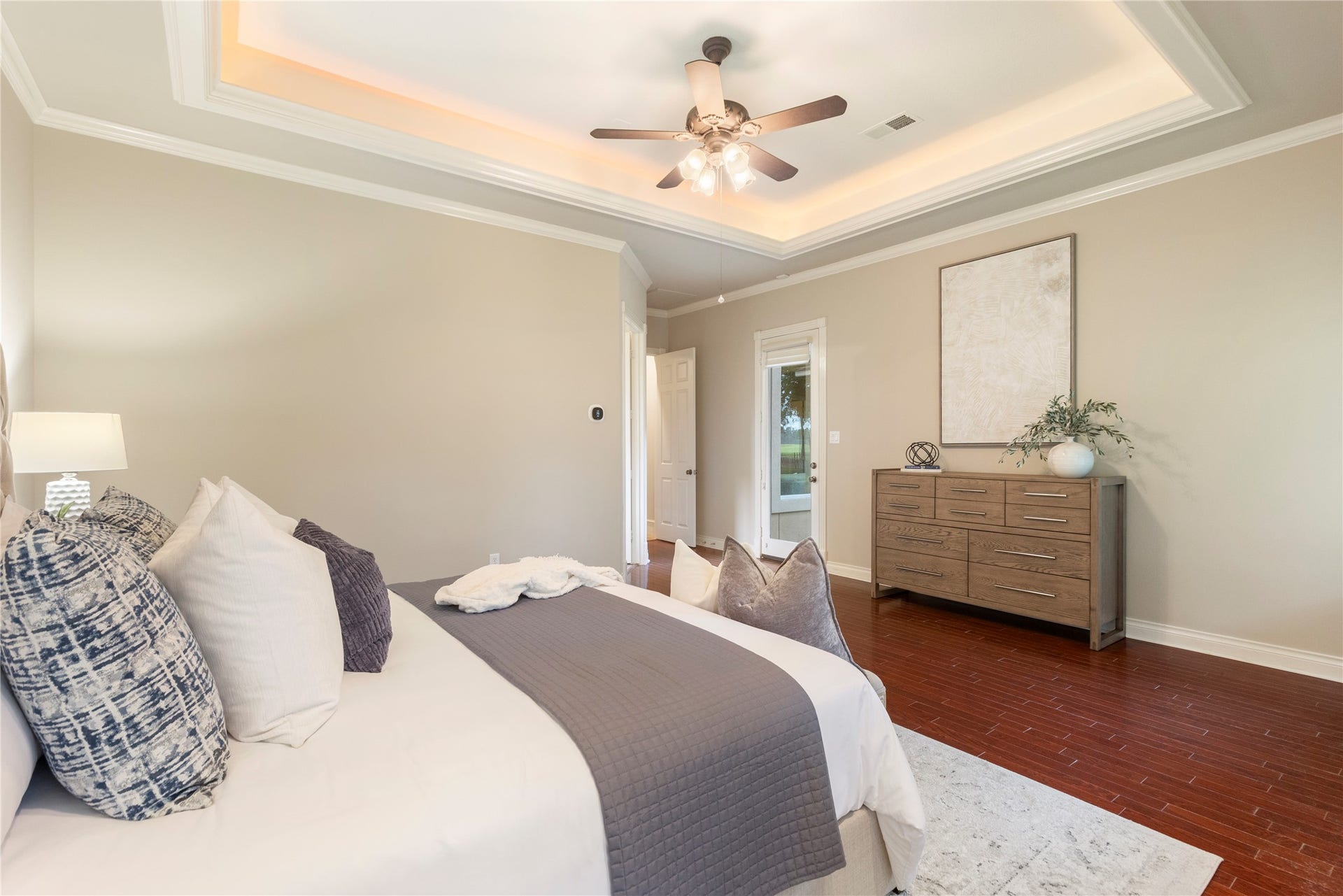 6207 Windrose Hollow Lane, Spring, TX 77379 Another angle of the primary suite shows the spacious layout and tray ceiling detail as well as the glass door to your backyard.