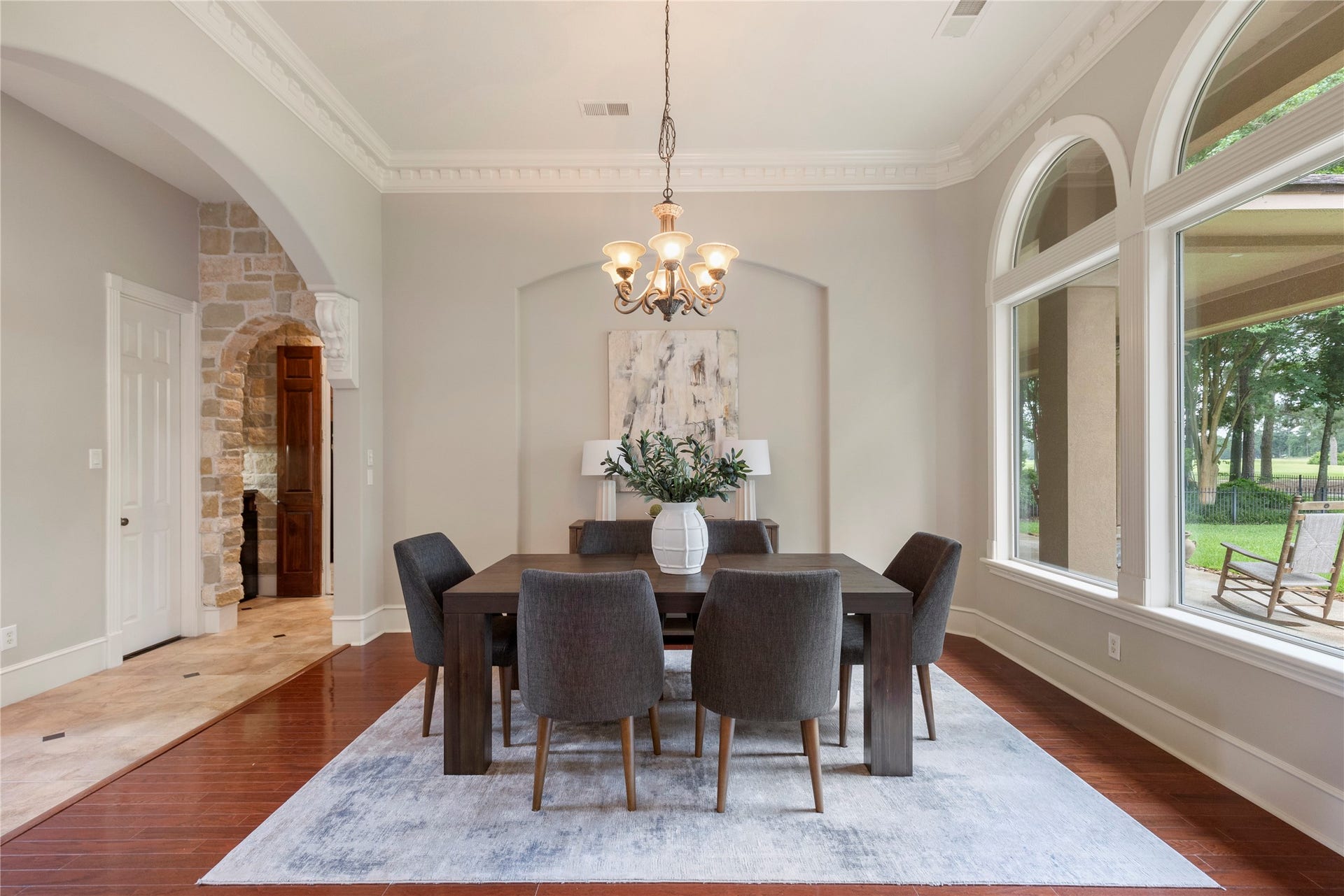 6207 Windrose Hollow Lane, Spring, TX 77379 The formal dining room is framed by arched windows and generous ceiling height, creating a refined backdrop for holidays and special gatherings. Golf course views add a memorable layer to the dining experience.