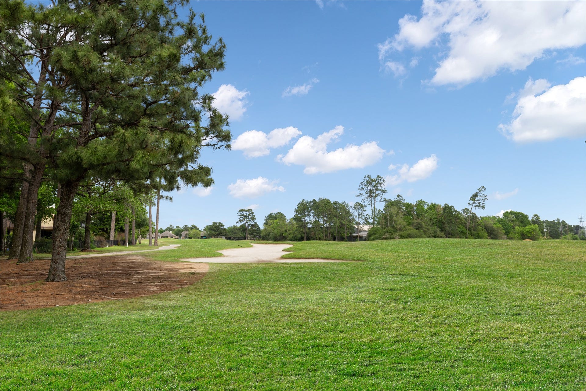 6207 Windrose Hollow Lane, Spring, TX 77379 The broad backyard opens toward the fairway, creating an expansive visual connection to nature. The property feels especially peaceful.