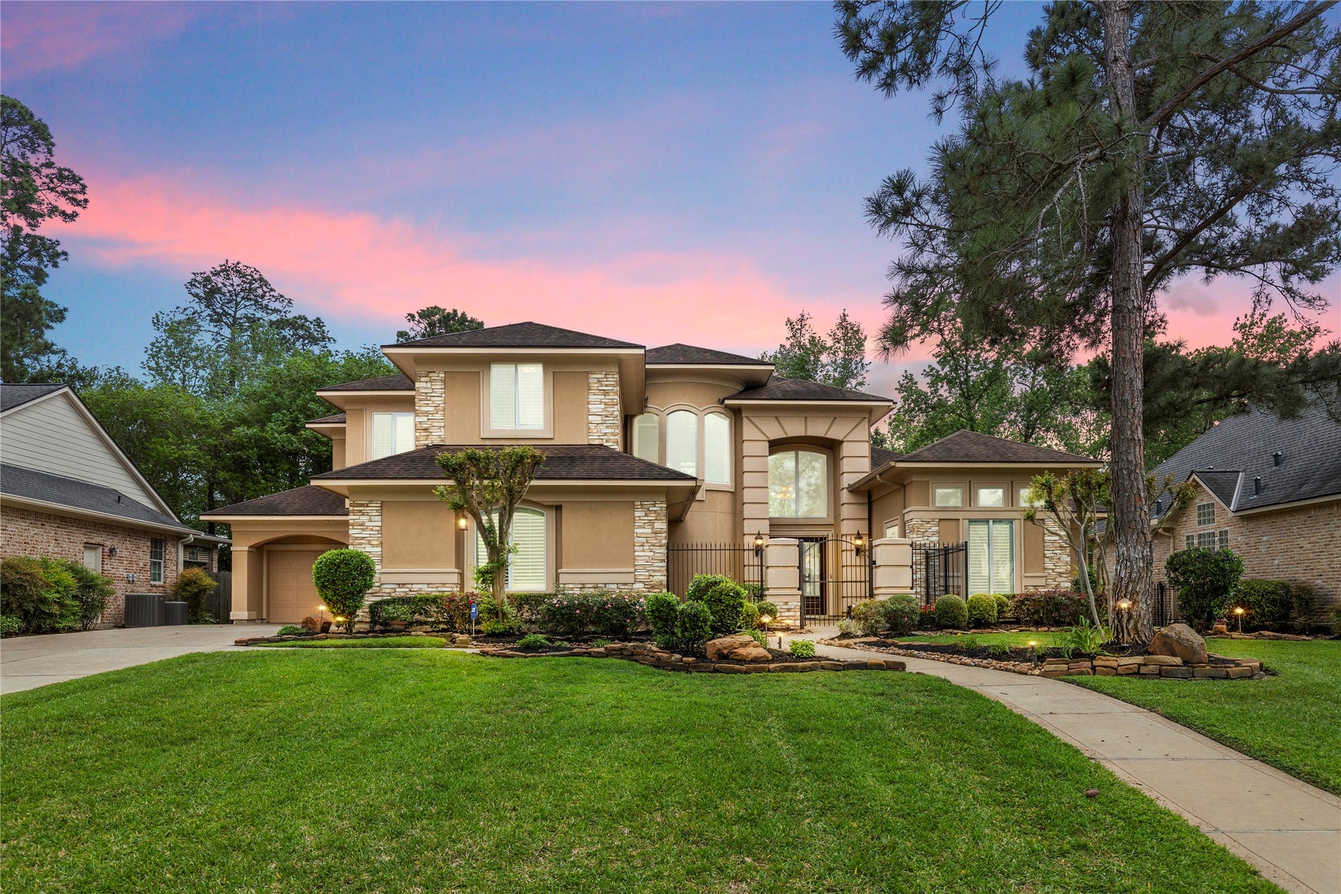 6207 Windrose Hollow Lane, Spring, TX 77379 The front elevation at sunset captures the homes stately architecture and timeless presence. It is a fitting final image for a custom residence with grand interiors, epic views, and an exceptional Windrose location.