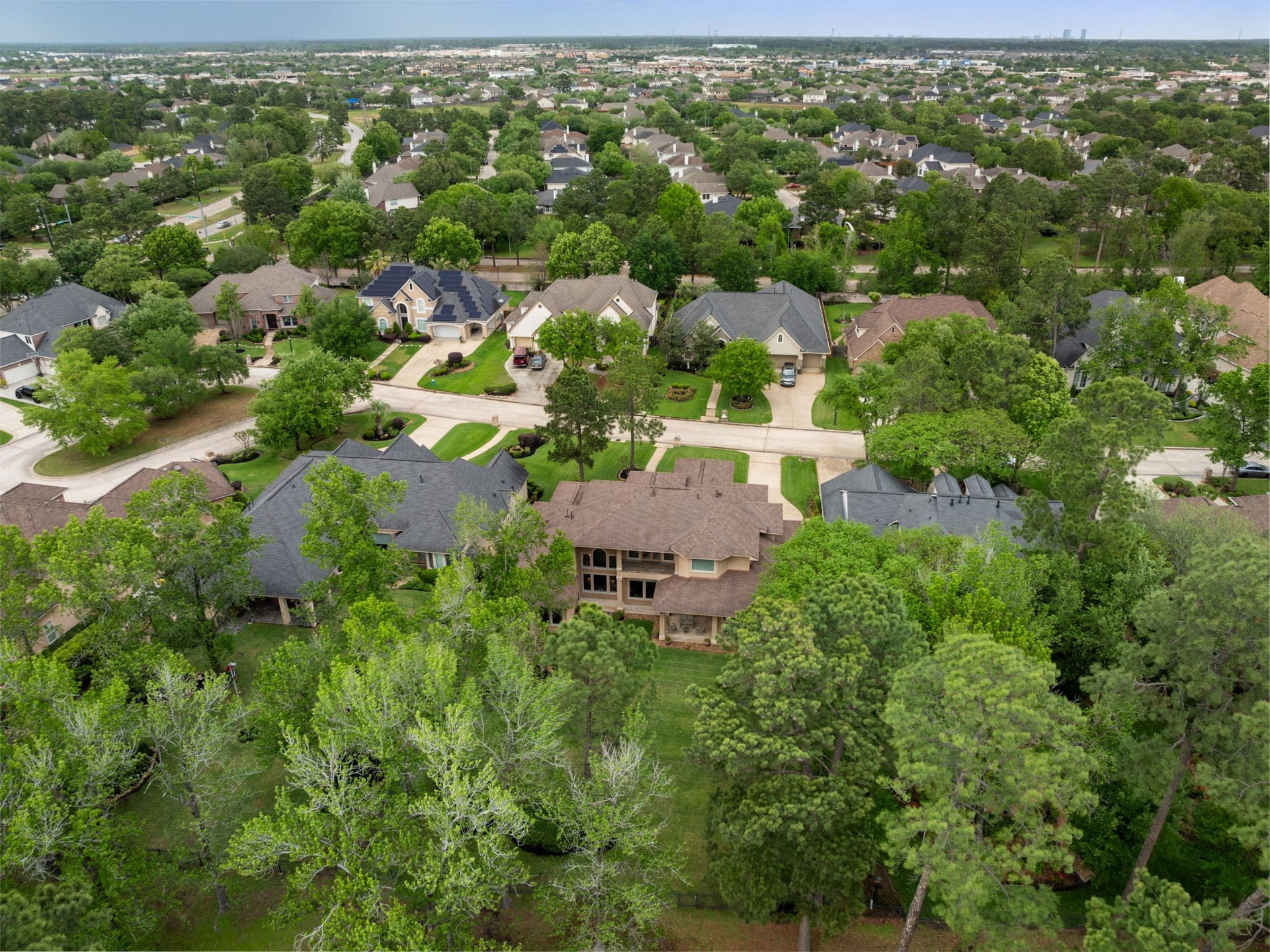 6207 Windrose Hollow Lane, Spring, TX 77379 Aerial perspective highlights the homes placement within an established golf course community. The setting offers a tucked away feel while remaining close to daily conveniences.