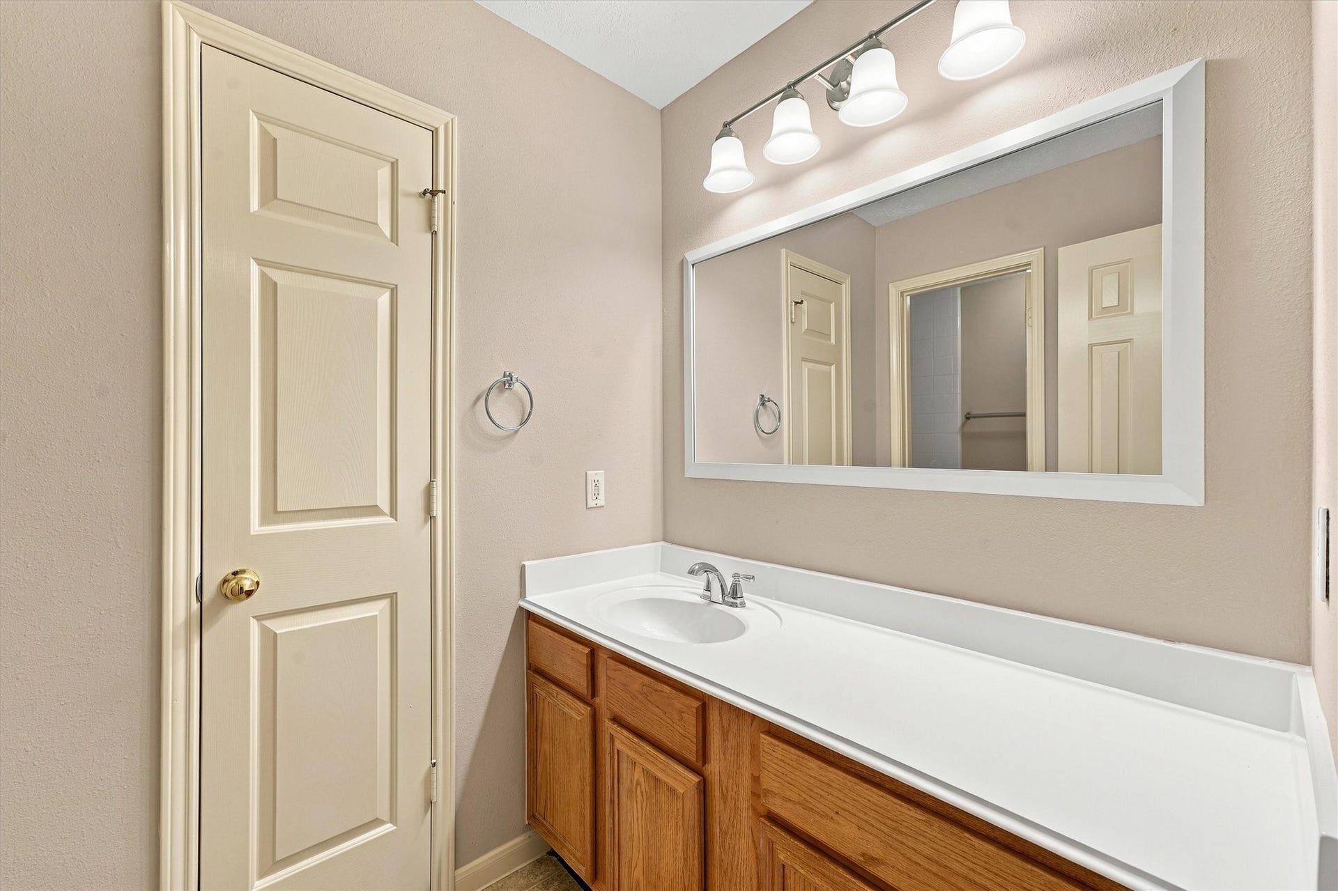 this secondary bathroom, featuring a sleek vanity, ample storage, and elegant lighting that creates a welcoming and functional space.