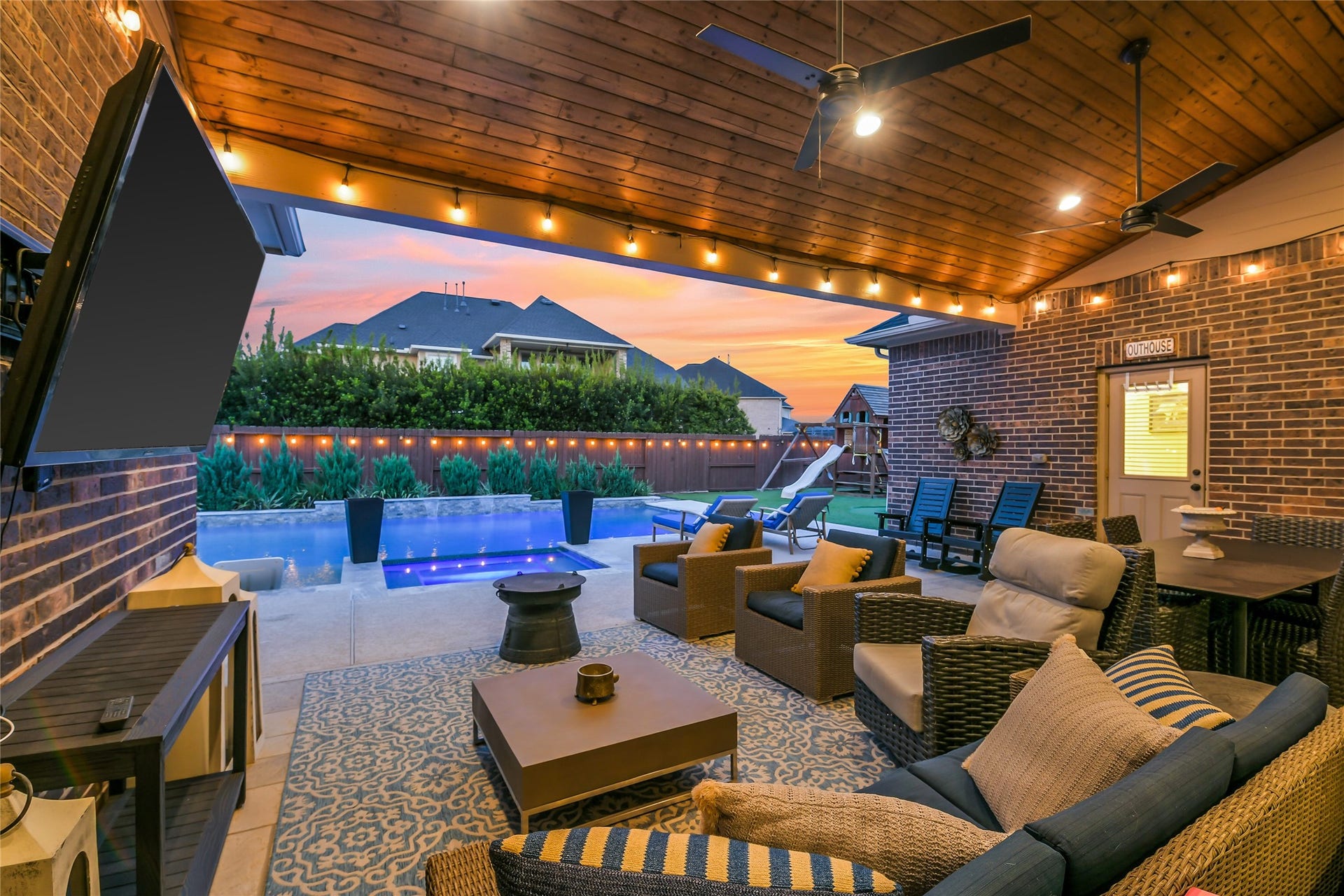 5410 Briarcliff Lane, Fulshear, TX 77441 Expansive covered outdoor living area with ample seating, a convenient pool bath, and seamless indoor-outdoor entertaining.