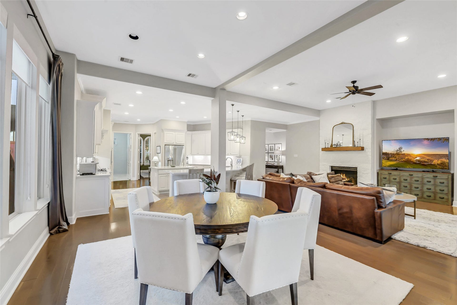 5410 Briarcliff Lane, Fulshear, TX 77441 This angle beautifully showcases the seamless flow of the open-concept living, dining, and kitchen space.