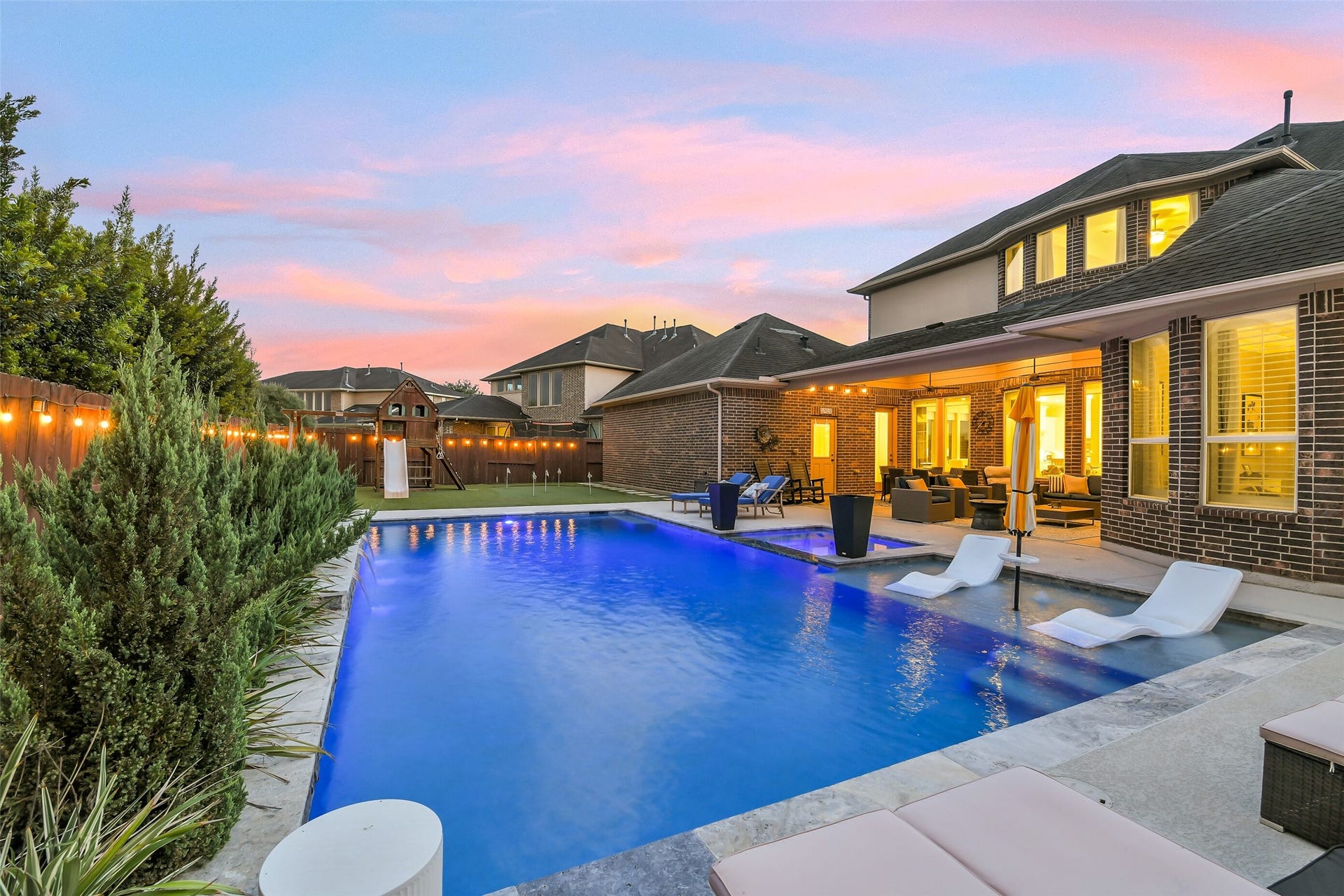5410 Briarcliff Lane, Fulshear, TX 77441 Enjoy resort-style outdoor living with a heated pool/spa, a custom putting green, and additional green space for golf practice, games, and family fun. An expansive covered patio and convenient outdoor pool bath make entertaining and relaxing effortless.